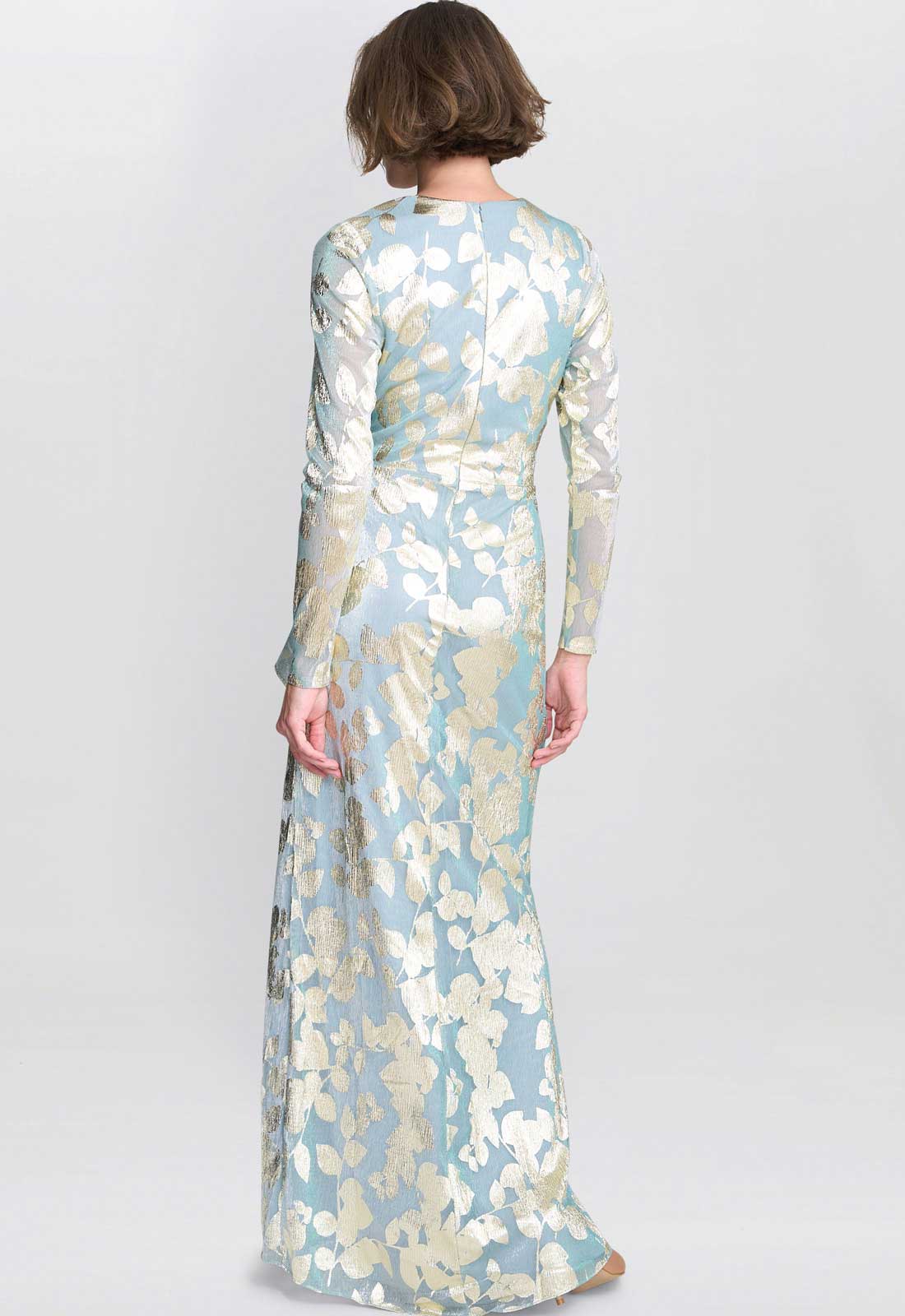 Woman wearing a floral dress with long sleeves on a white background