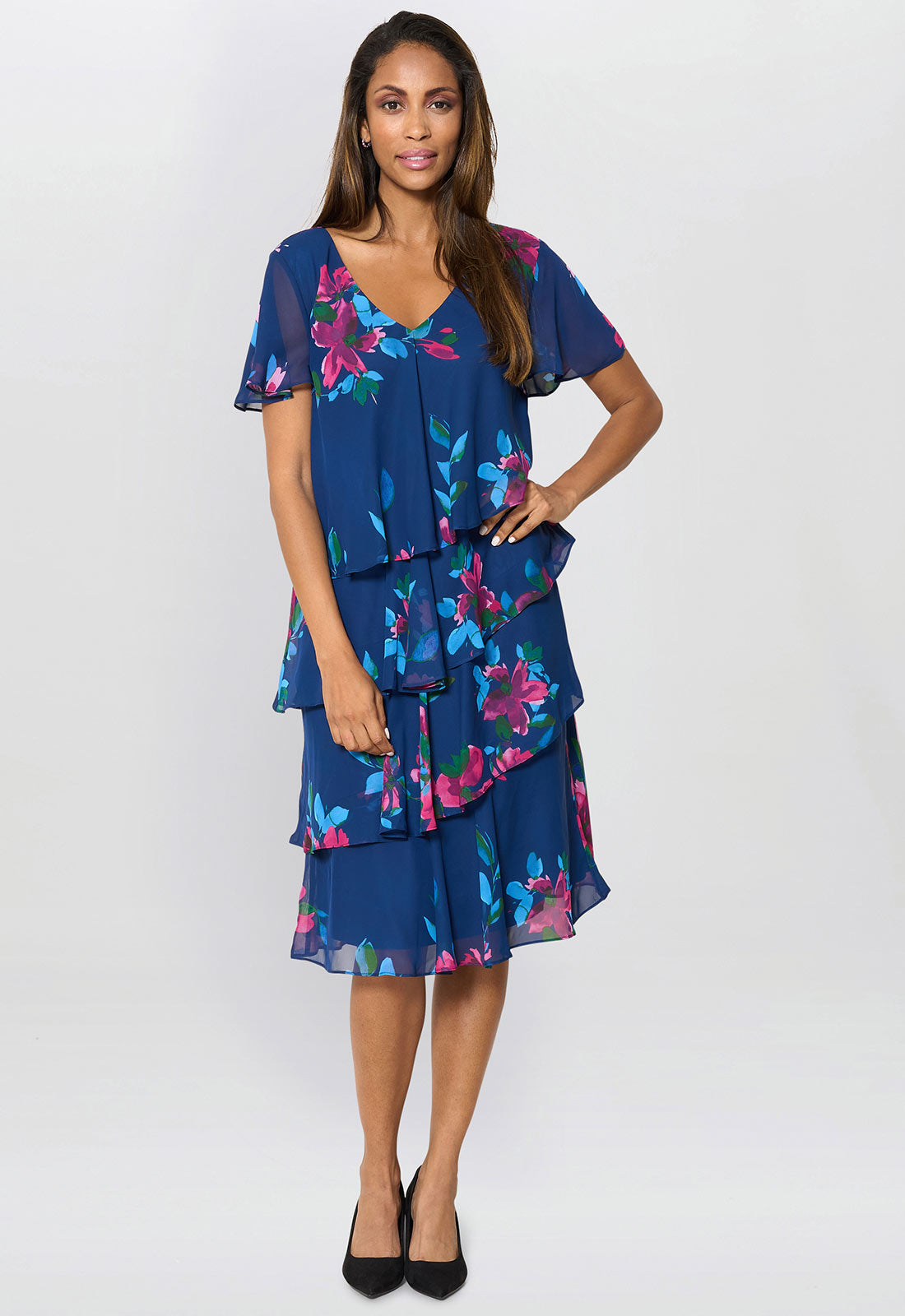 Woman wearing a blue floral dress on a white background