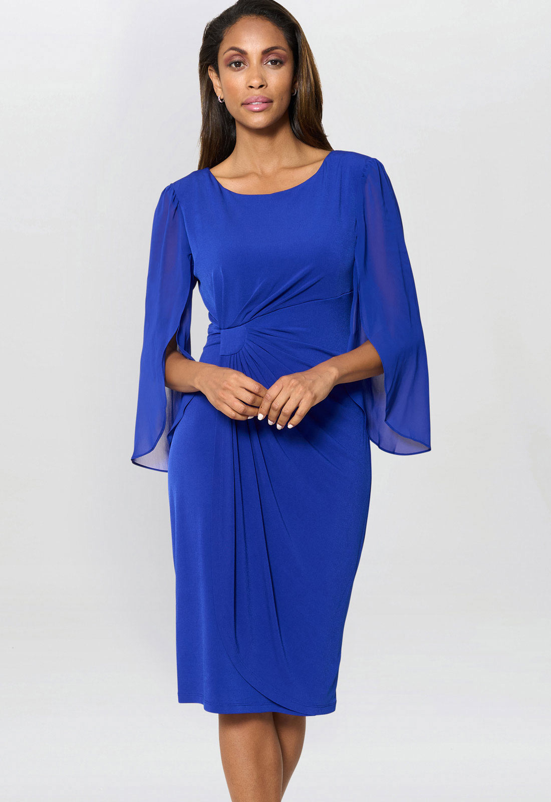 Woman wearing a blue dress with bell sleeves on a white background
