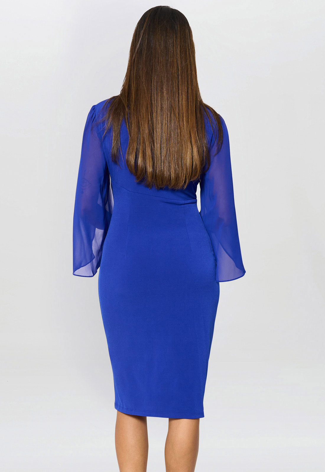 Woman wearing a blue dress with sheer sleeves on a white background