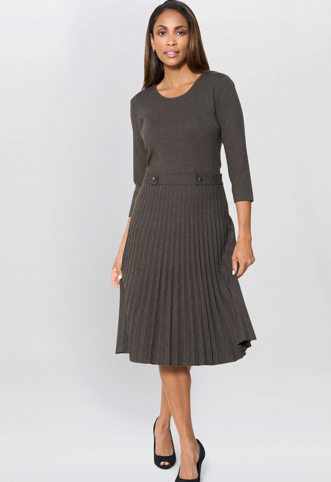 Woman wearing a gray dress with a plain background