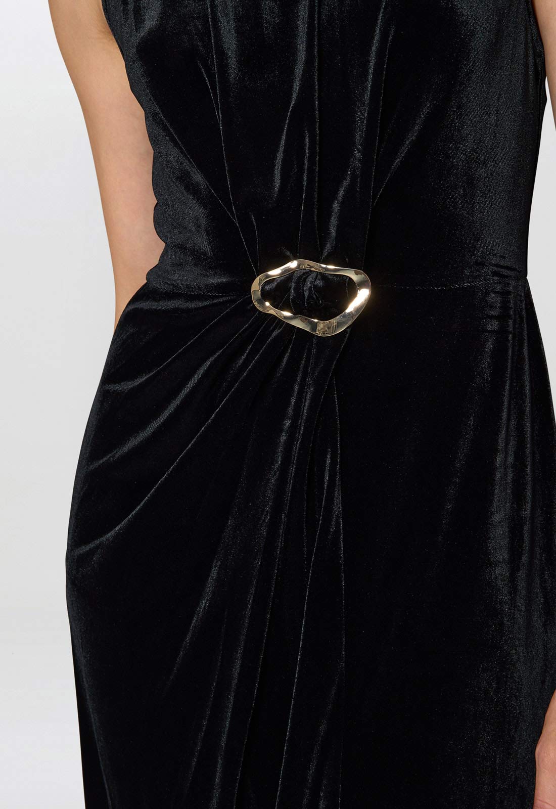 Black velvet dress with a gold belt on a white background