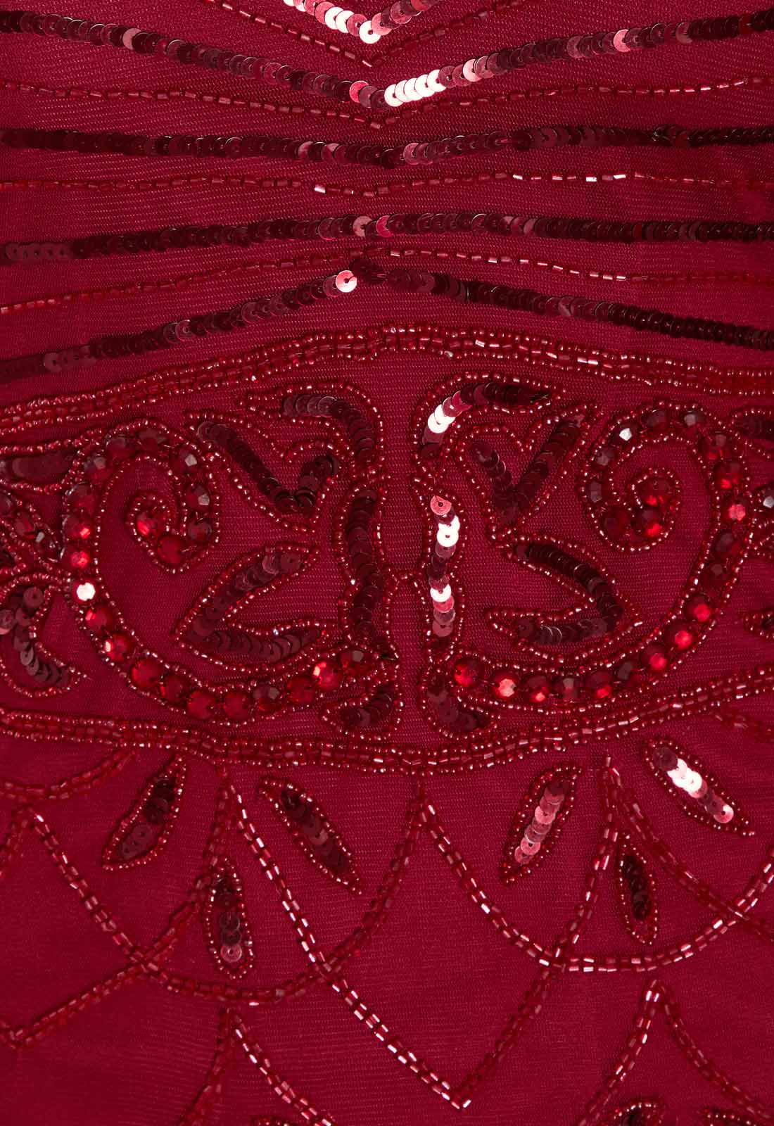 Close-up of a red fabric with intricate beadwork and patterns