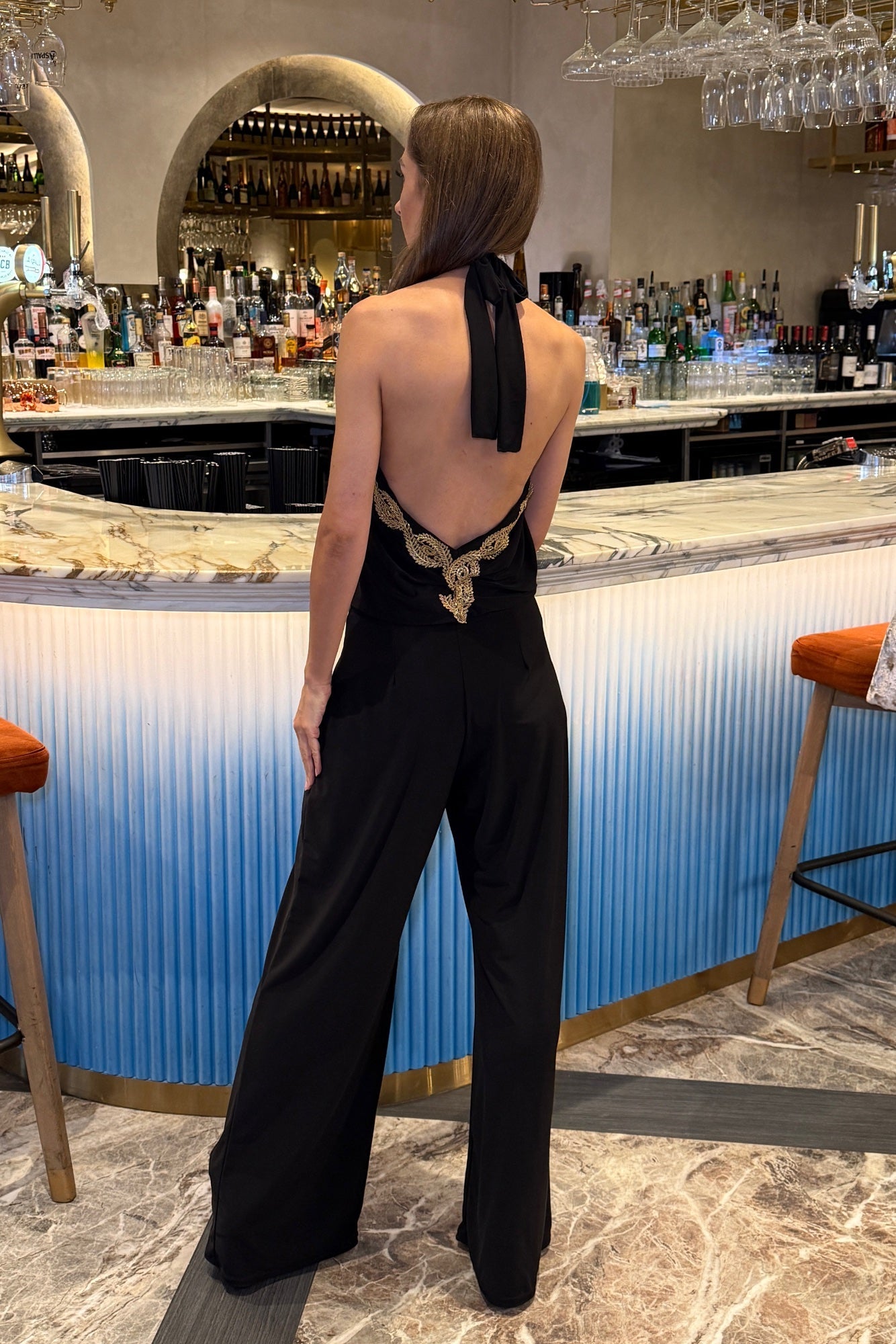 Sasha Black Backless Wide Leg Jumpsuit With Gold Leaf Trim - Front View | Honor Gold