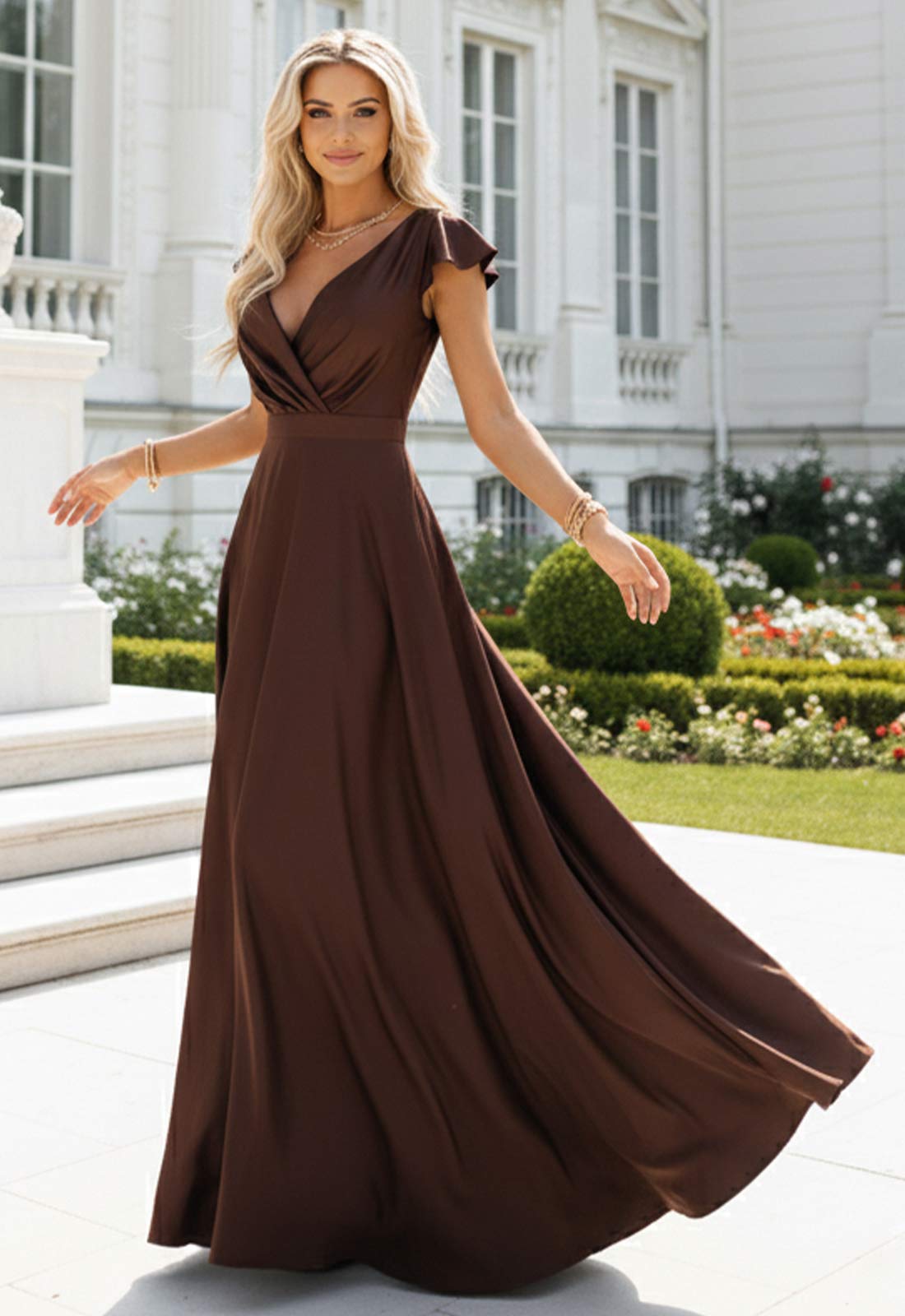 Woman in a brown evening gown standing in front of a classical building.