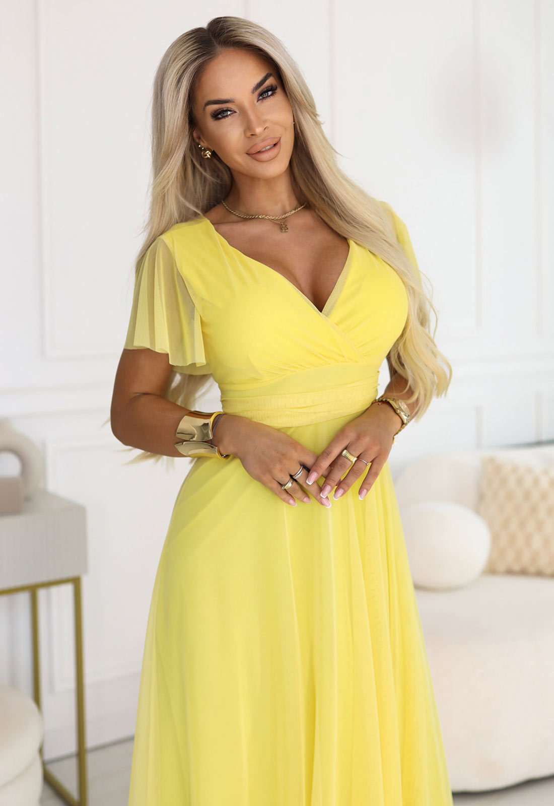Woman wearing a yellow dress in an indoor setting