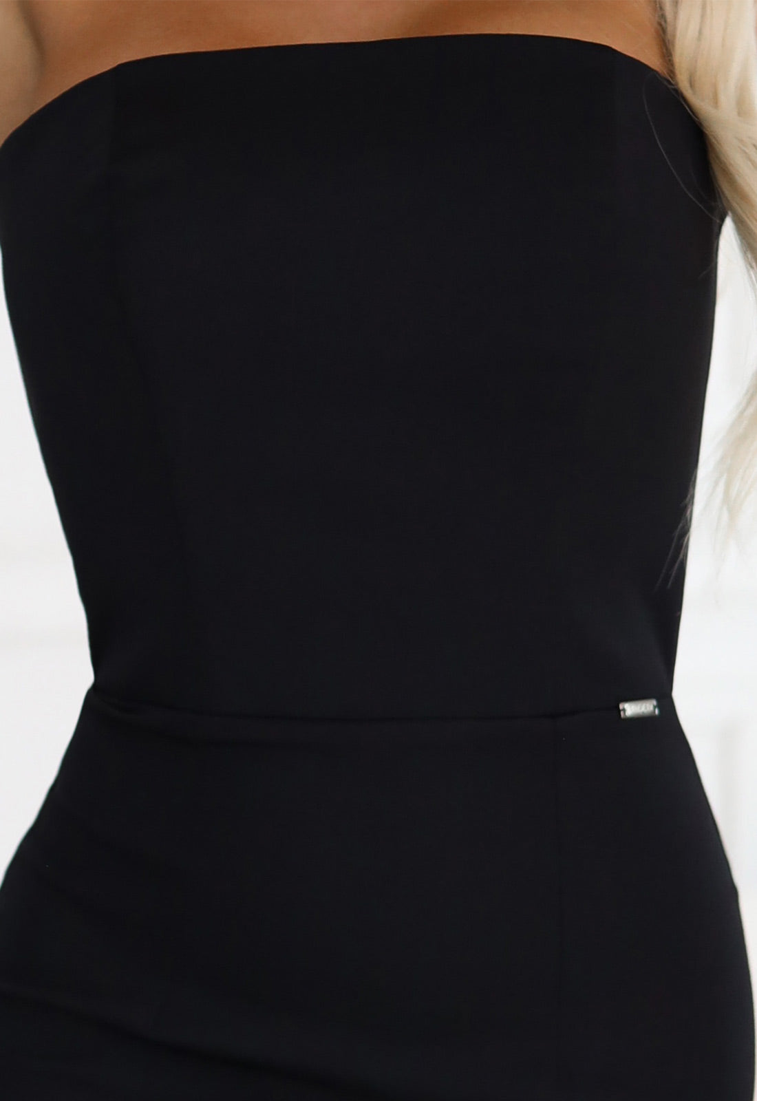 Black strapless dress on a white background