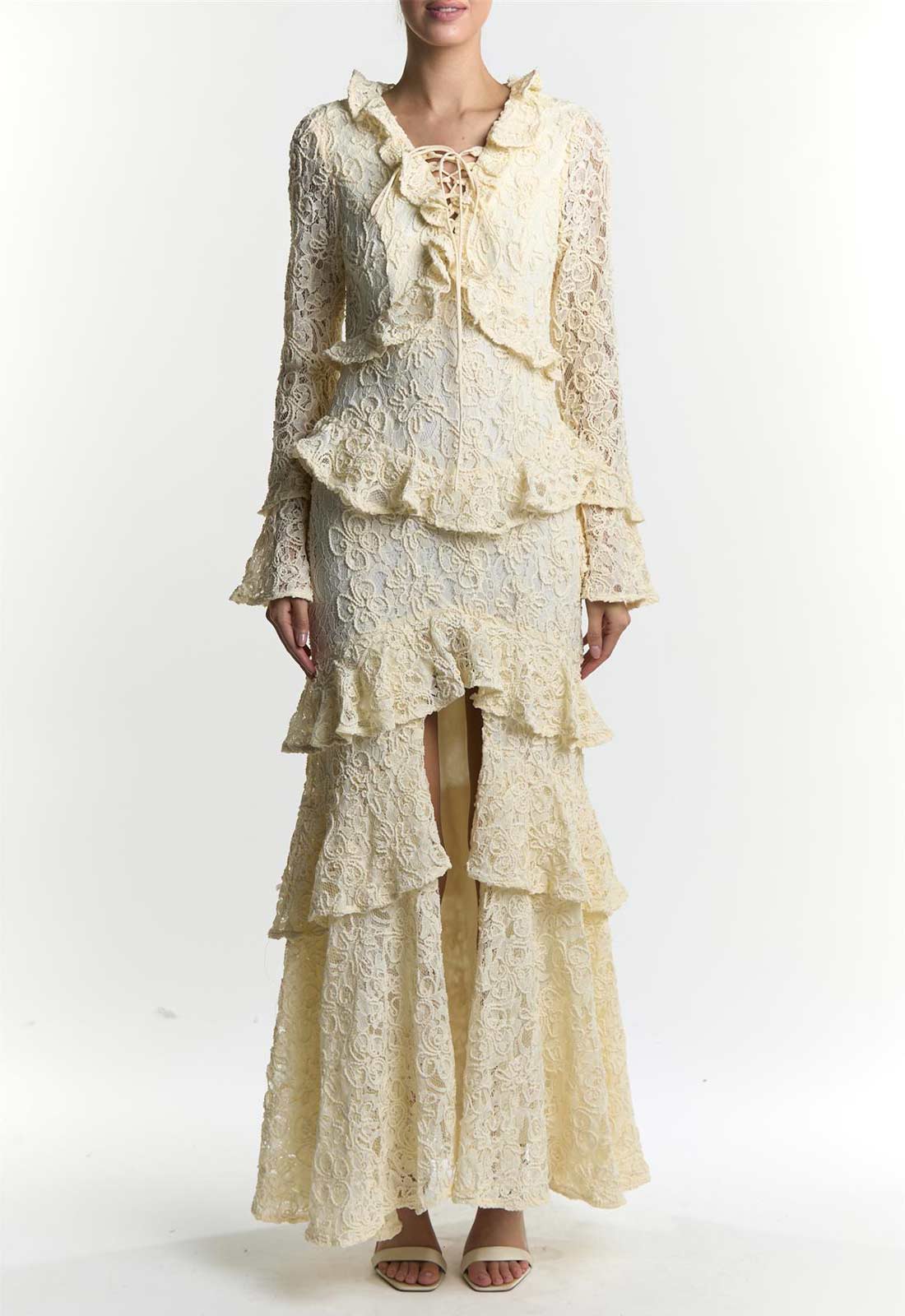 Woman wearing a cream-colored lace outfit on a white background