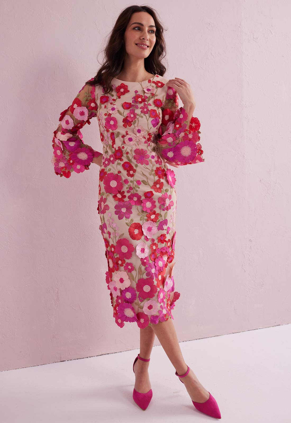 Woman wearing a floral dress with pink background