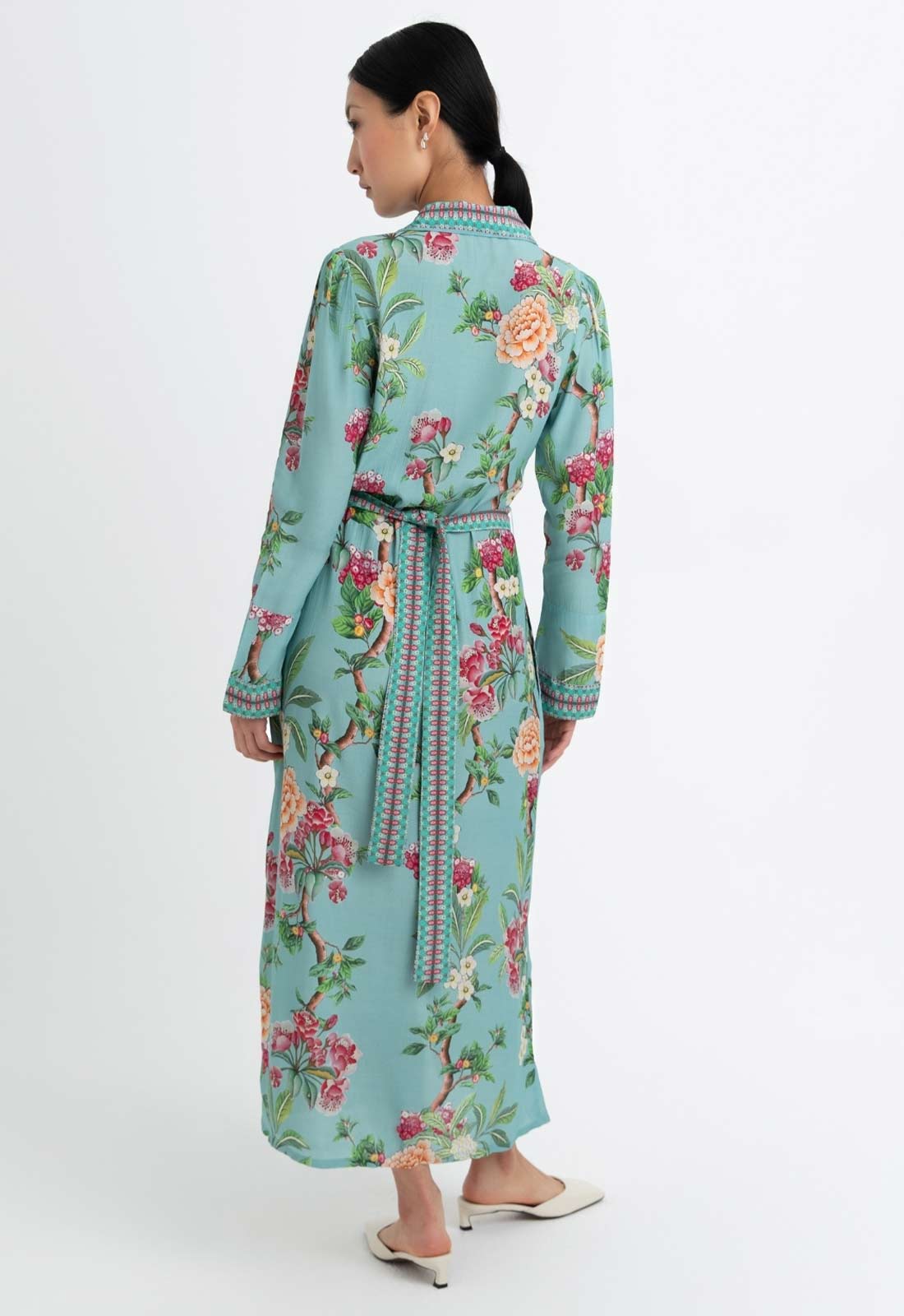 Woman wearing a floral dress with a white background