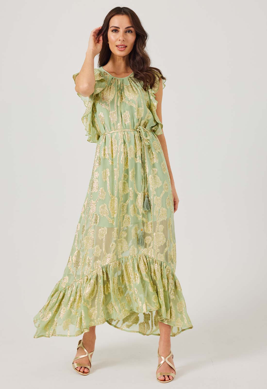 Woman wearing a green floral dress on a white background