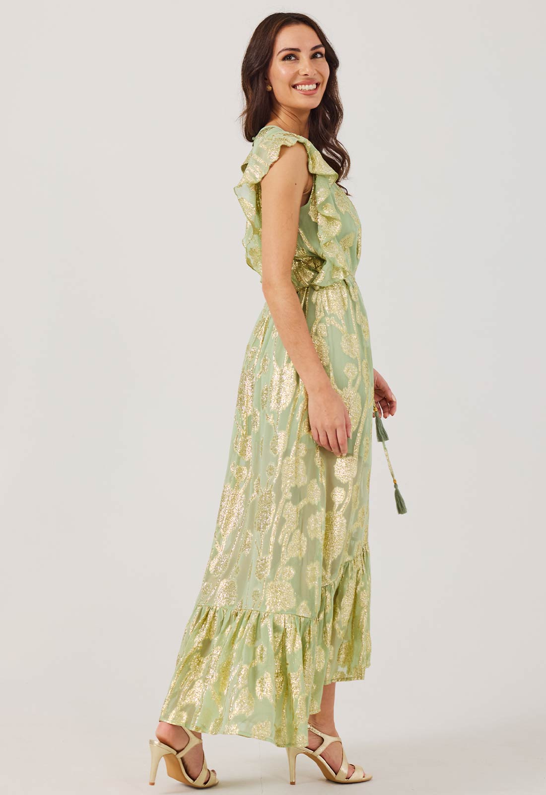 Woman wearing a green floral dress on a white background