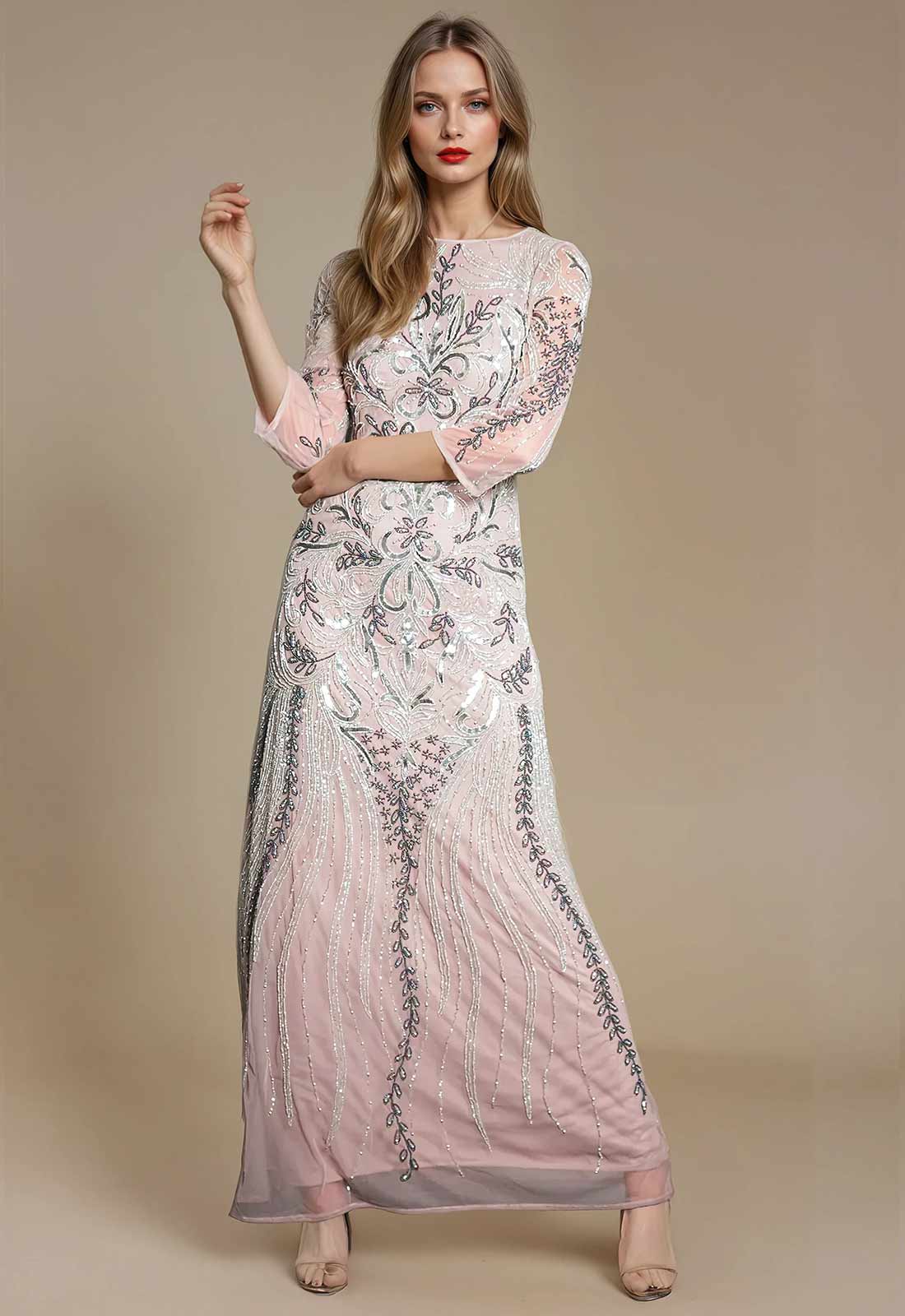 Woman wearing a long, elegant dress with floral patterns on a beige background