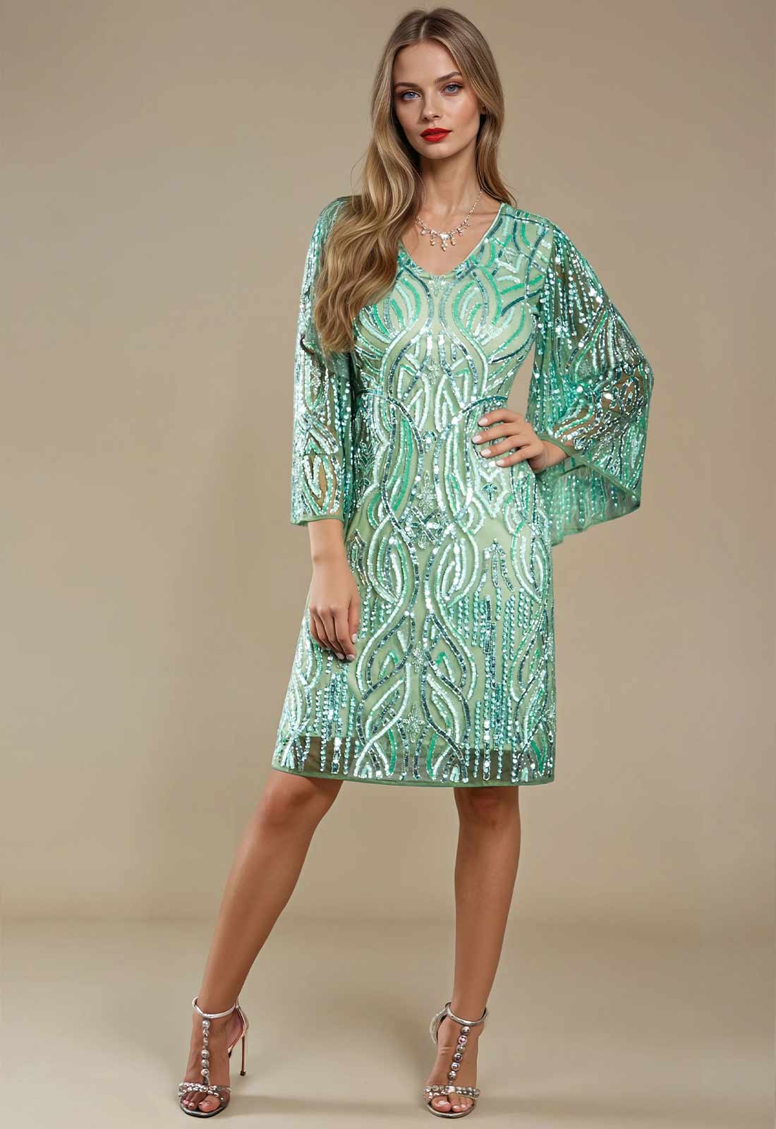Woman wearing a green sequin dress on a beige background