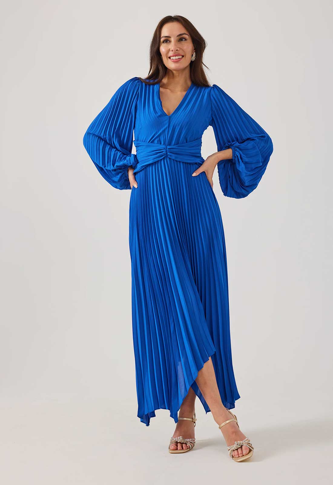 Woman wearing a blue pleated dress on a white background