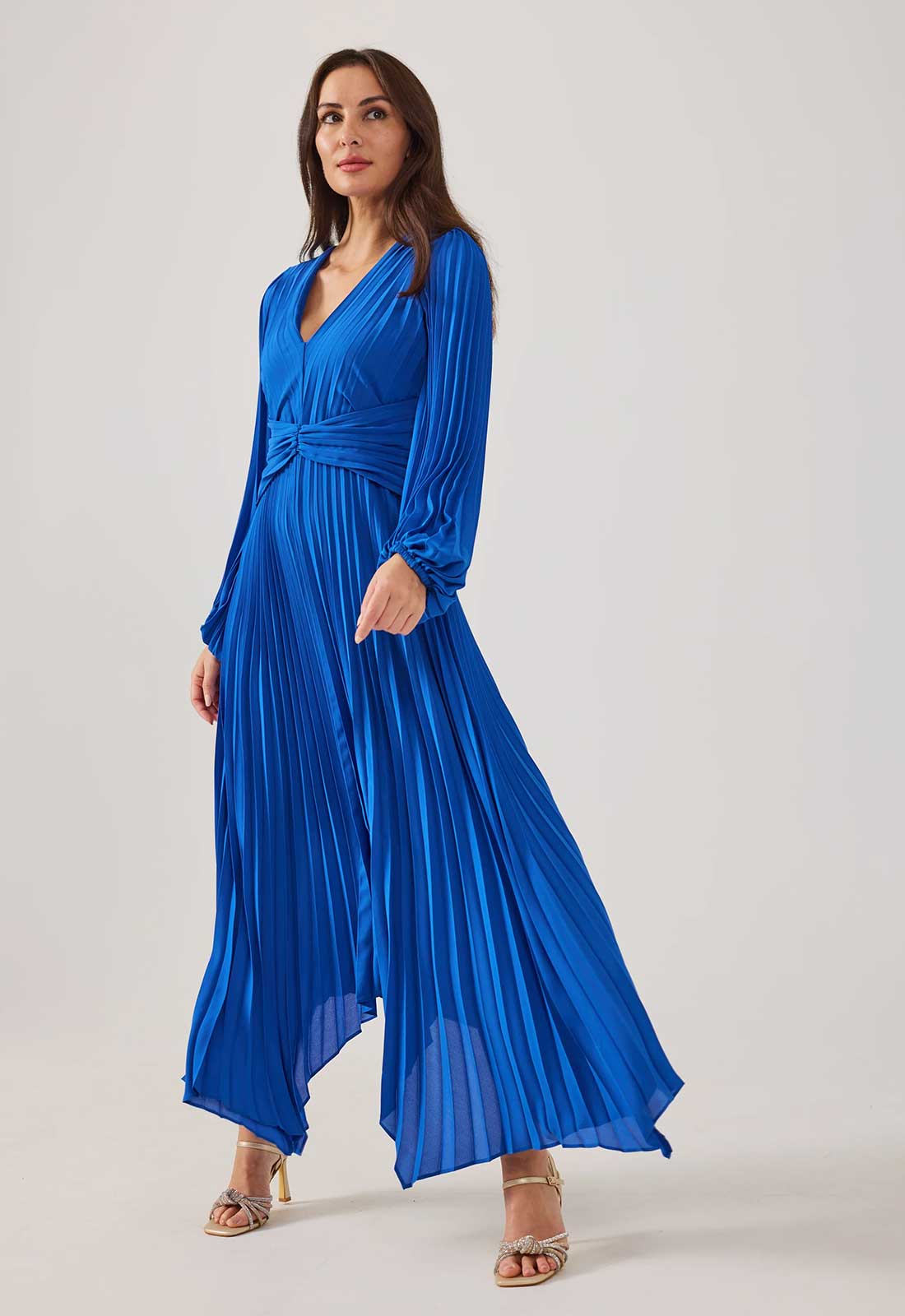 Woman wearing a blue dress against a white background