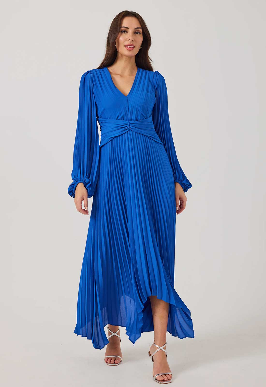 Woman wearing a blue pleated dress on a white background