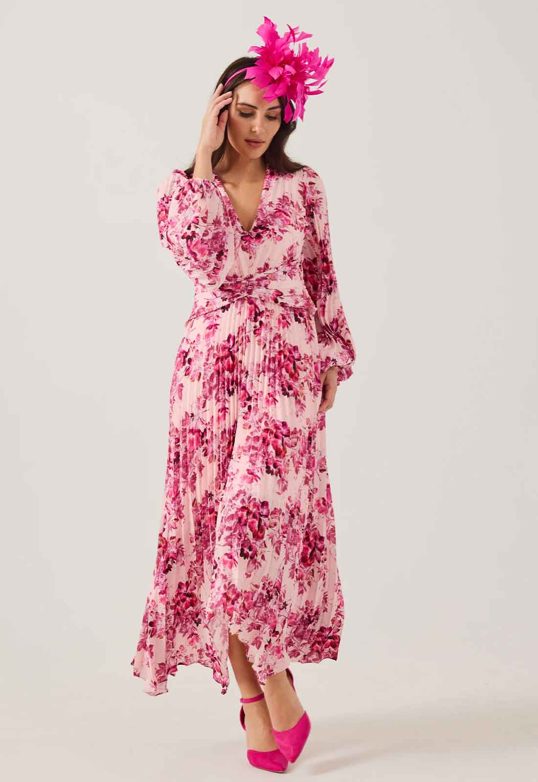 Woman wearing a pink floral dress and headpiece on a white background