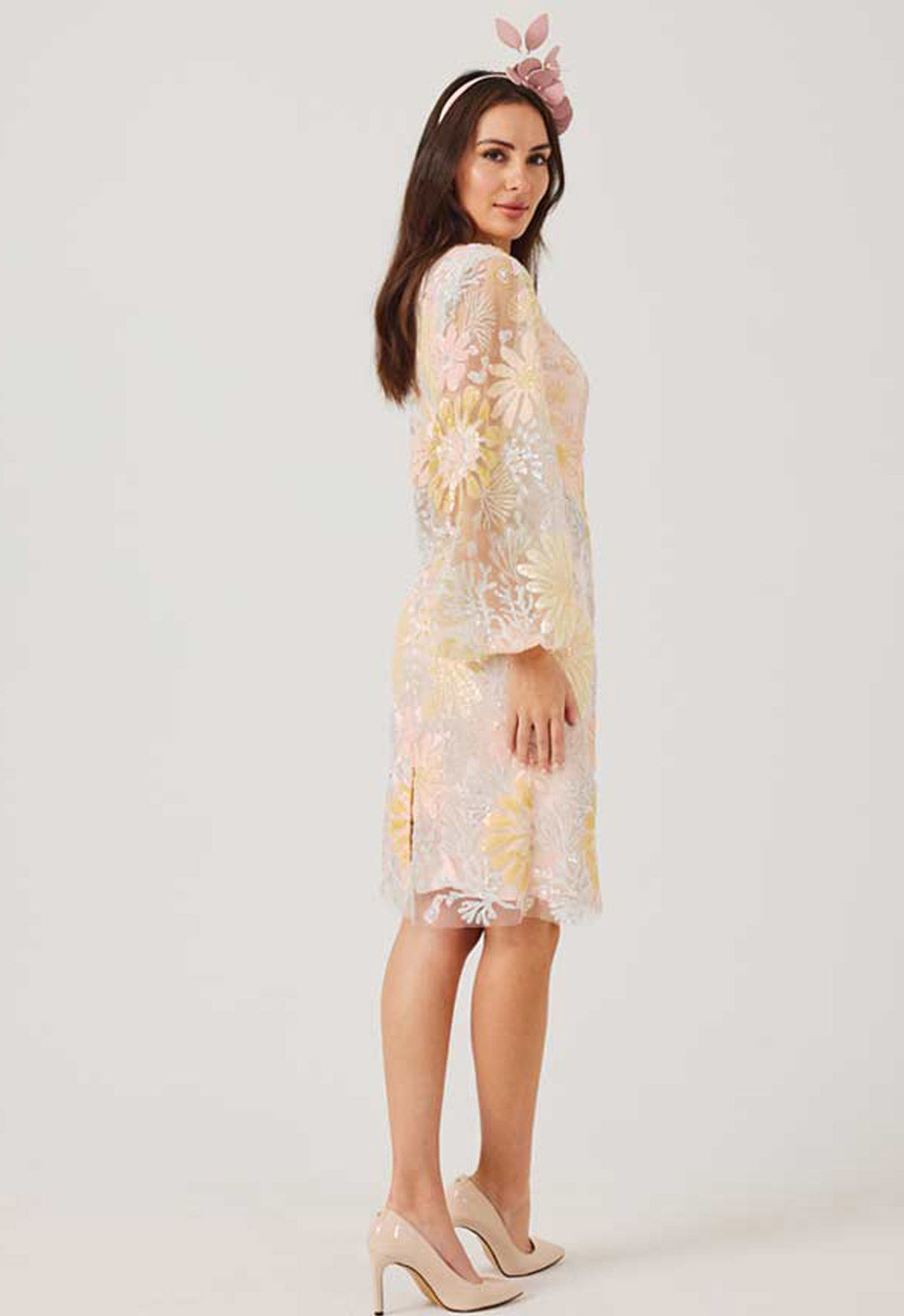 Woman wearing a floral dress with a white background