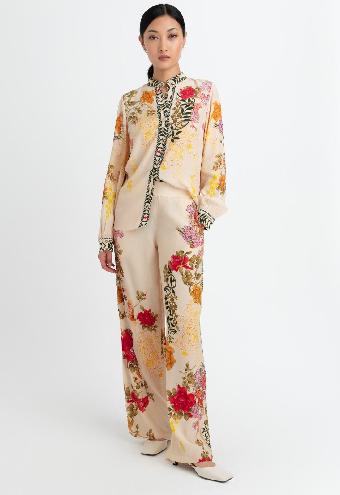 Woman wearing a floral outfit on a white background