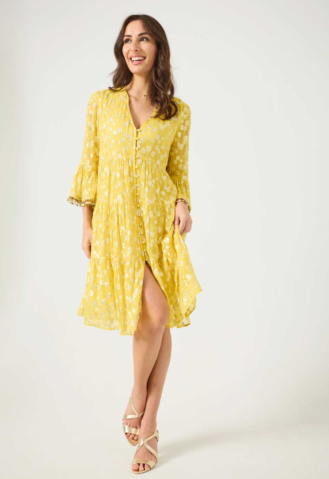 Woman wearing a yellow dress with a white background