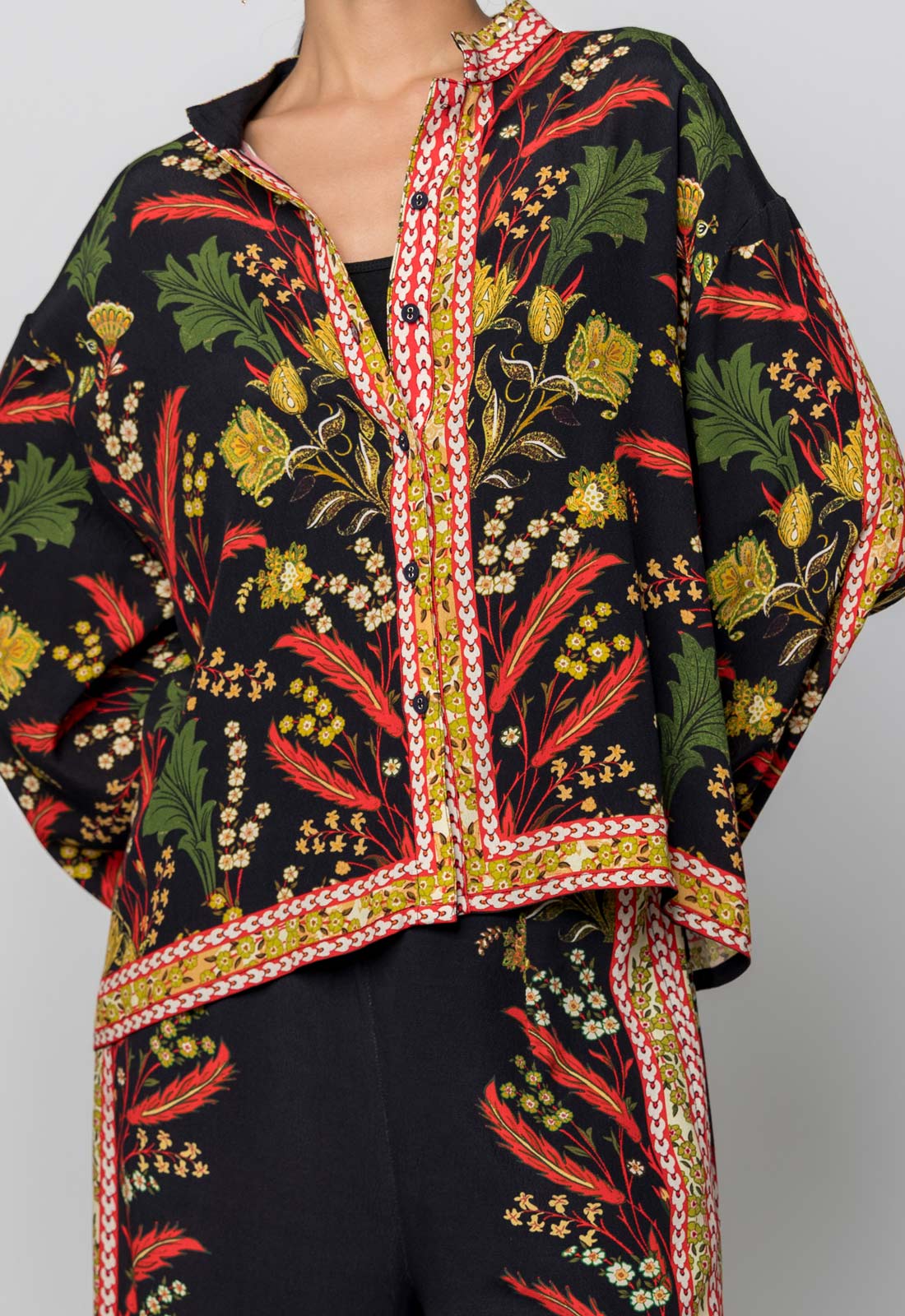 Floral patterned jacket with a colorful border on a plain background