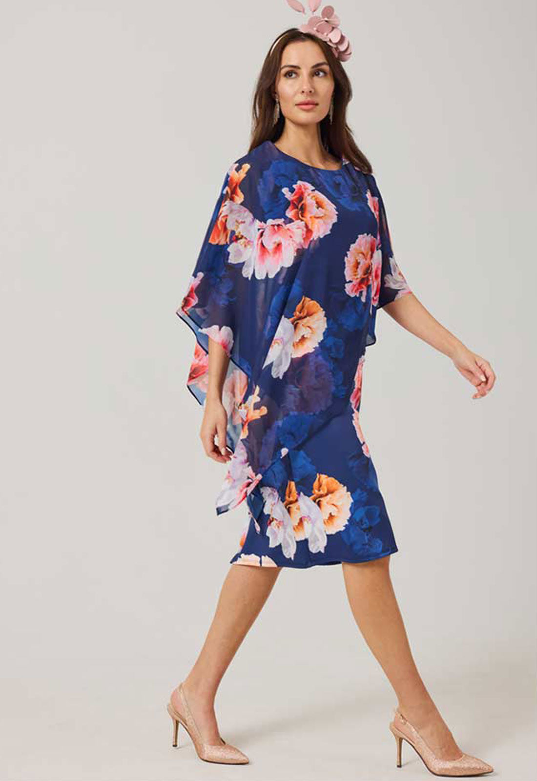 Woman wearing a floral dress with a white background