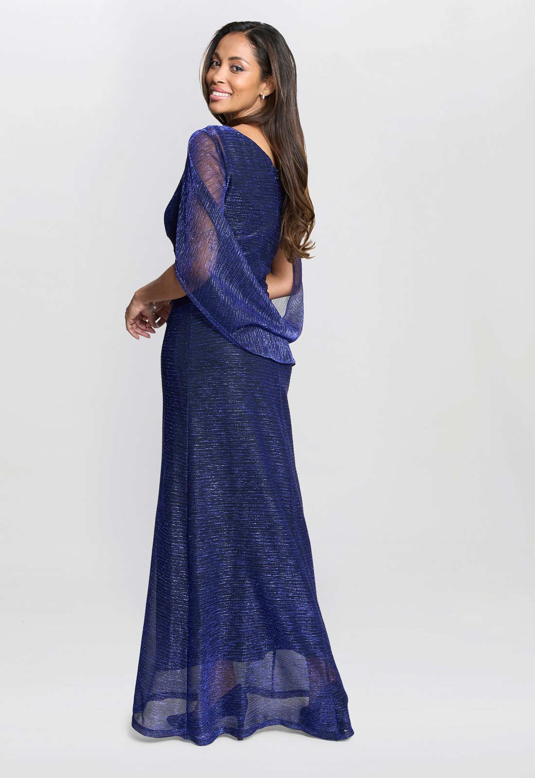 Woman wearing a blue evening gown against a white background