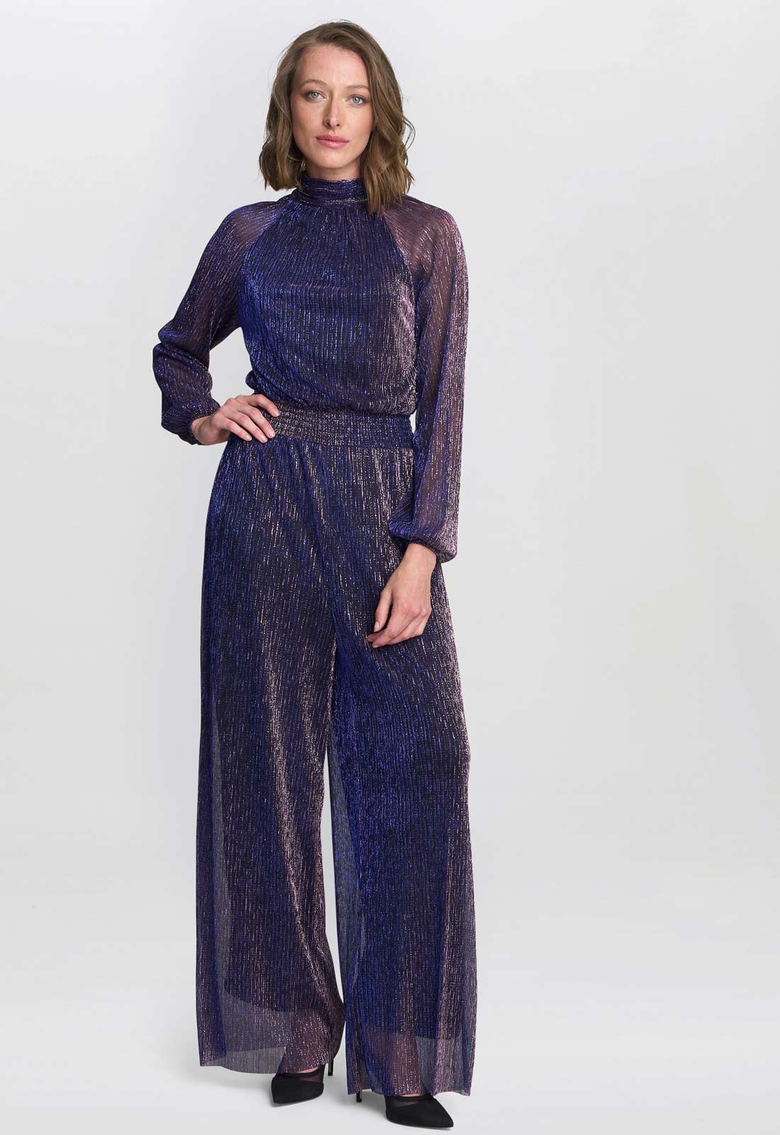 Woman wearing a dark blue patterned outfit on a white background
