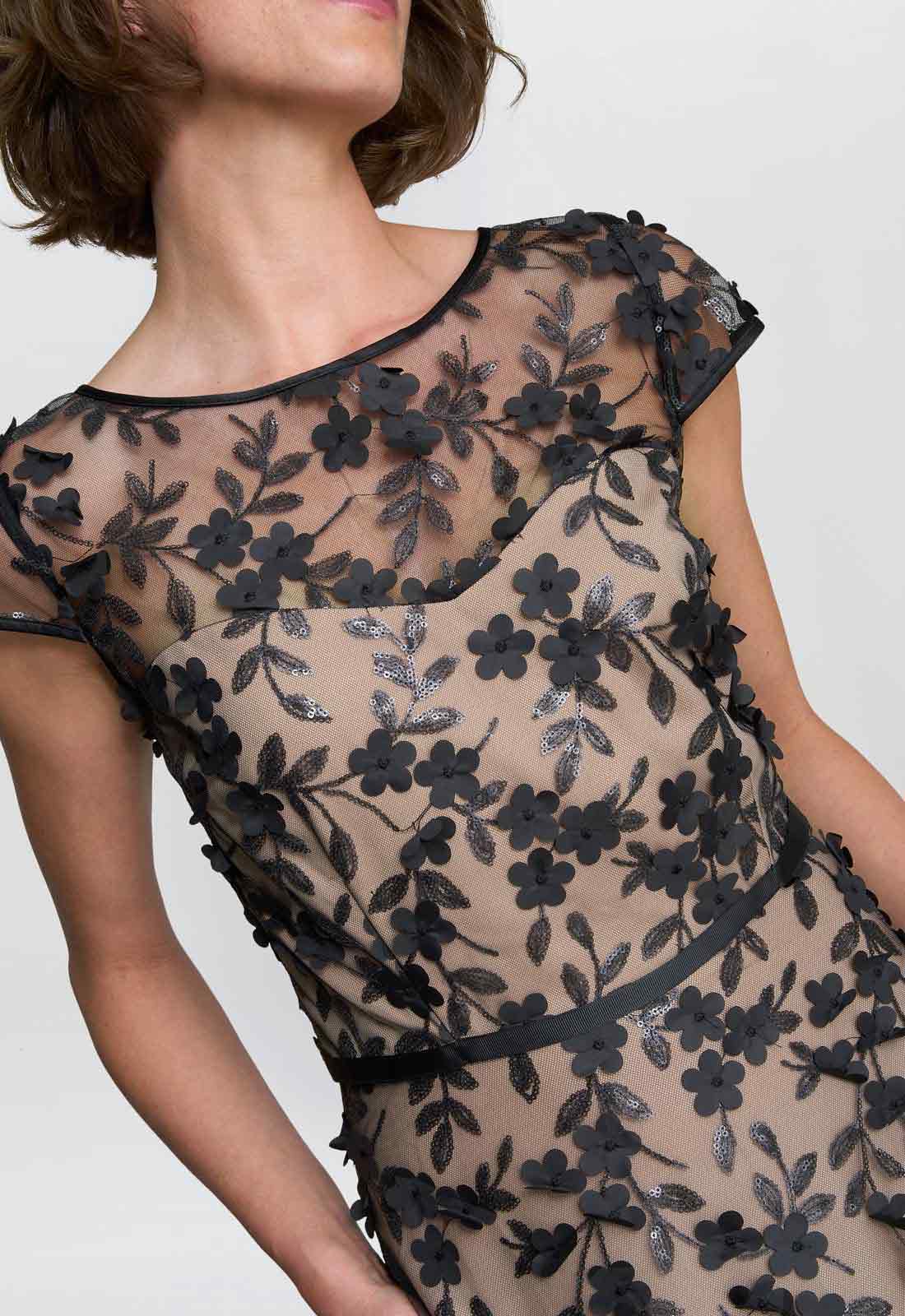 Black floral lace dress on a plain background