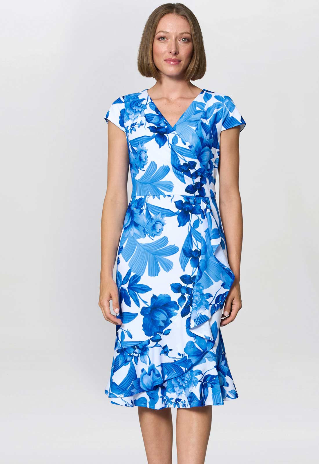 Woman wearing a blue floral dress on a white background