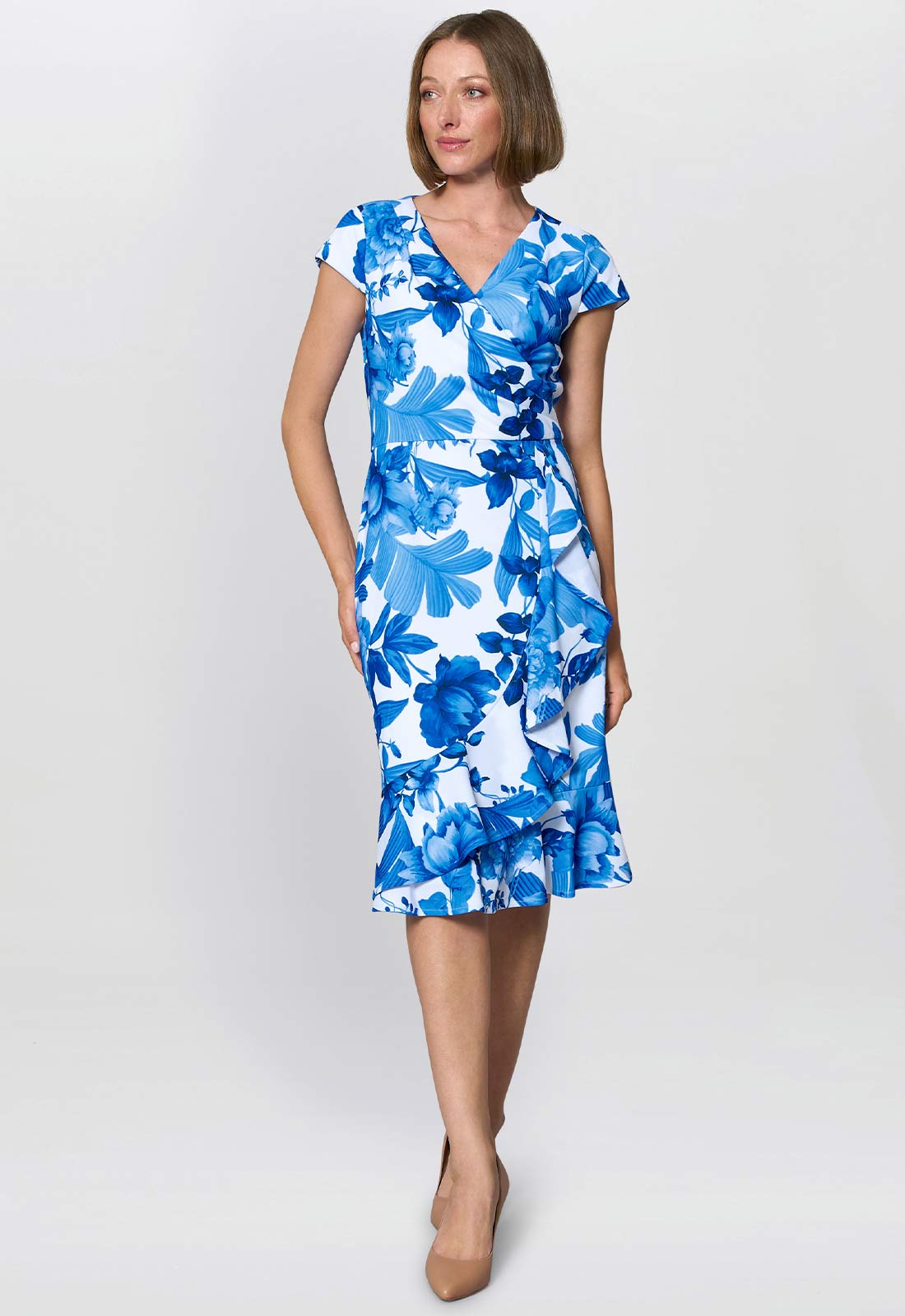 Woman wearing a blue floral dress on a white background