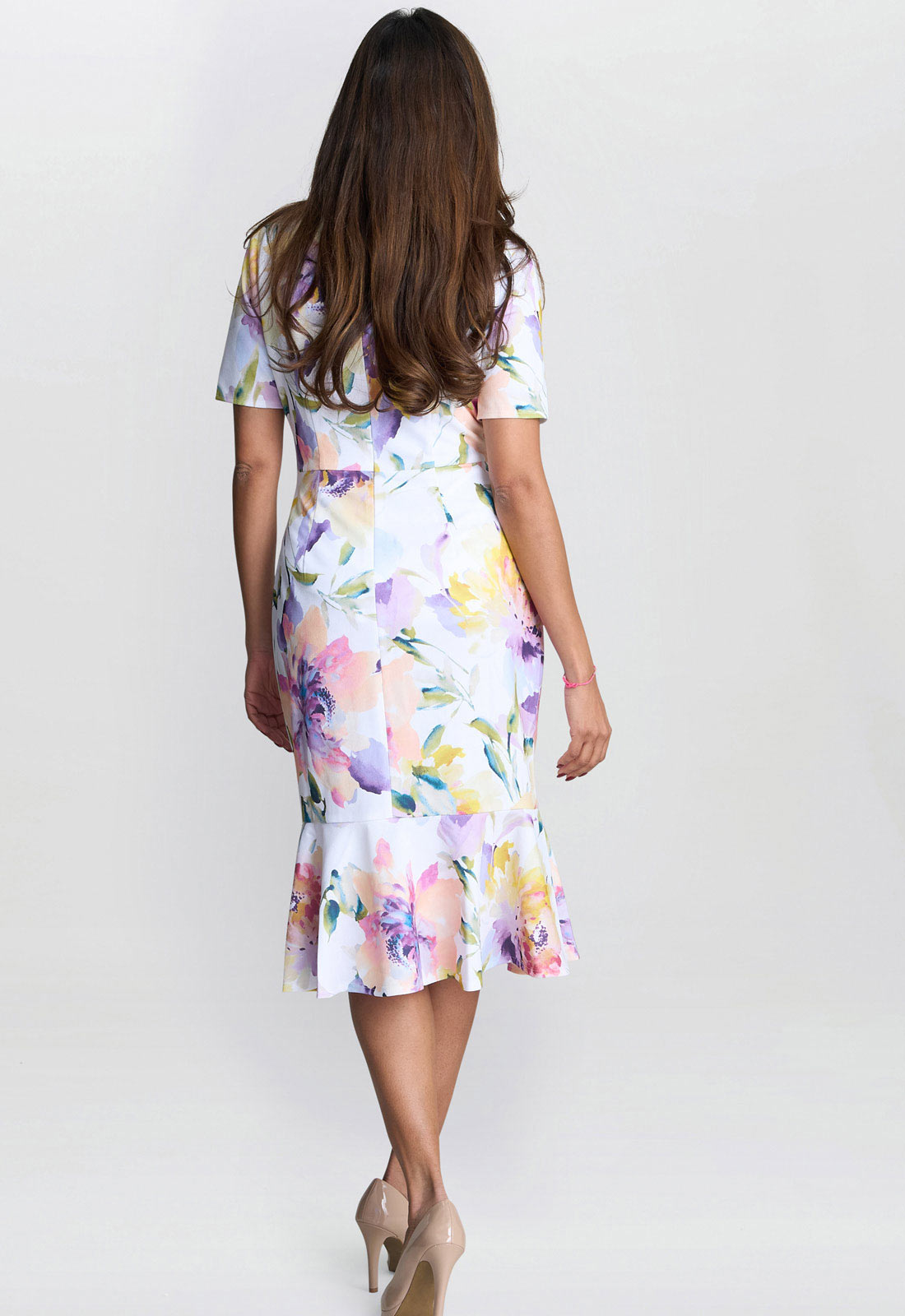 Woman wearing a floral dress on a white background