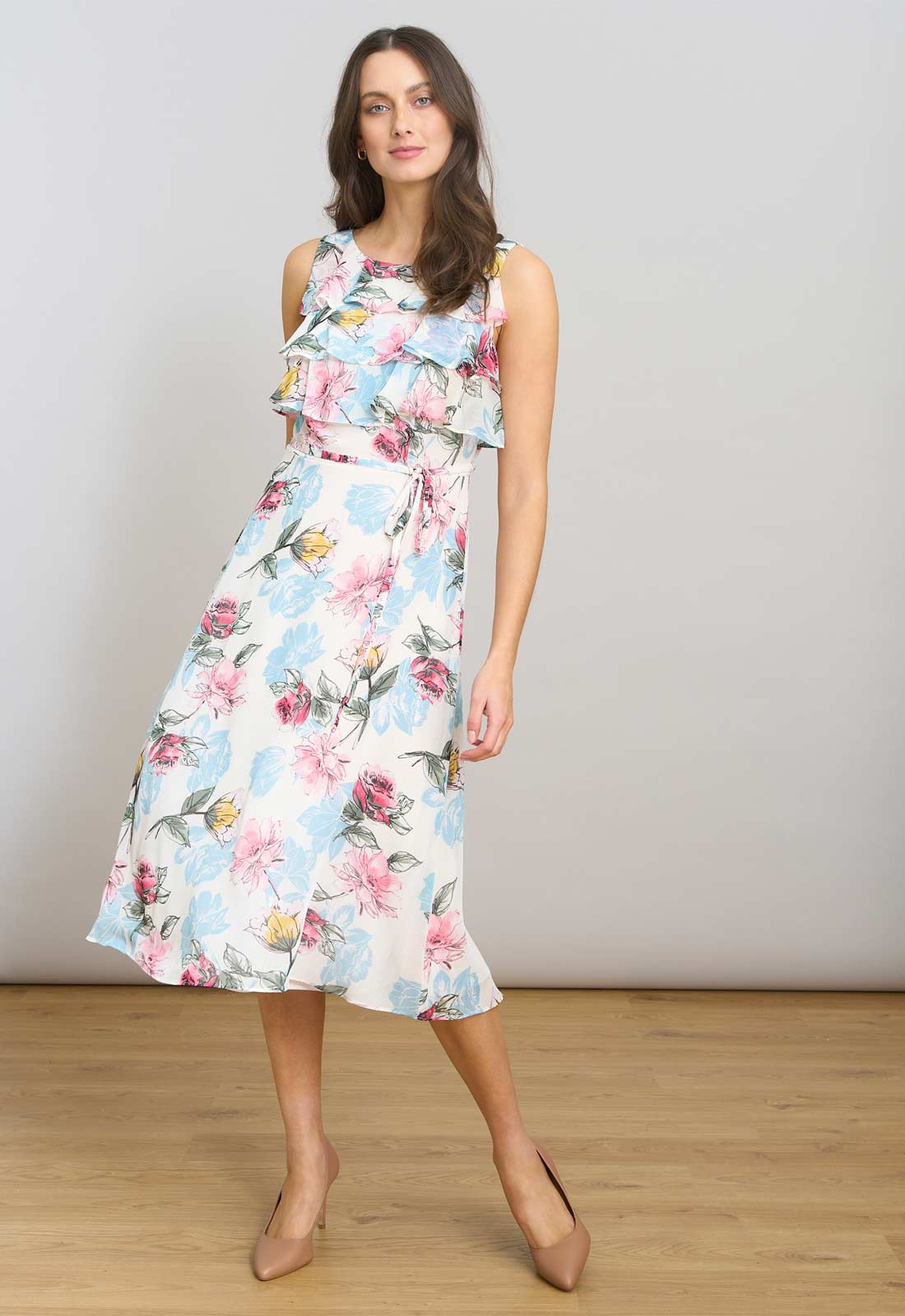 Woman wearing a floral dress on a plain background
