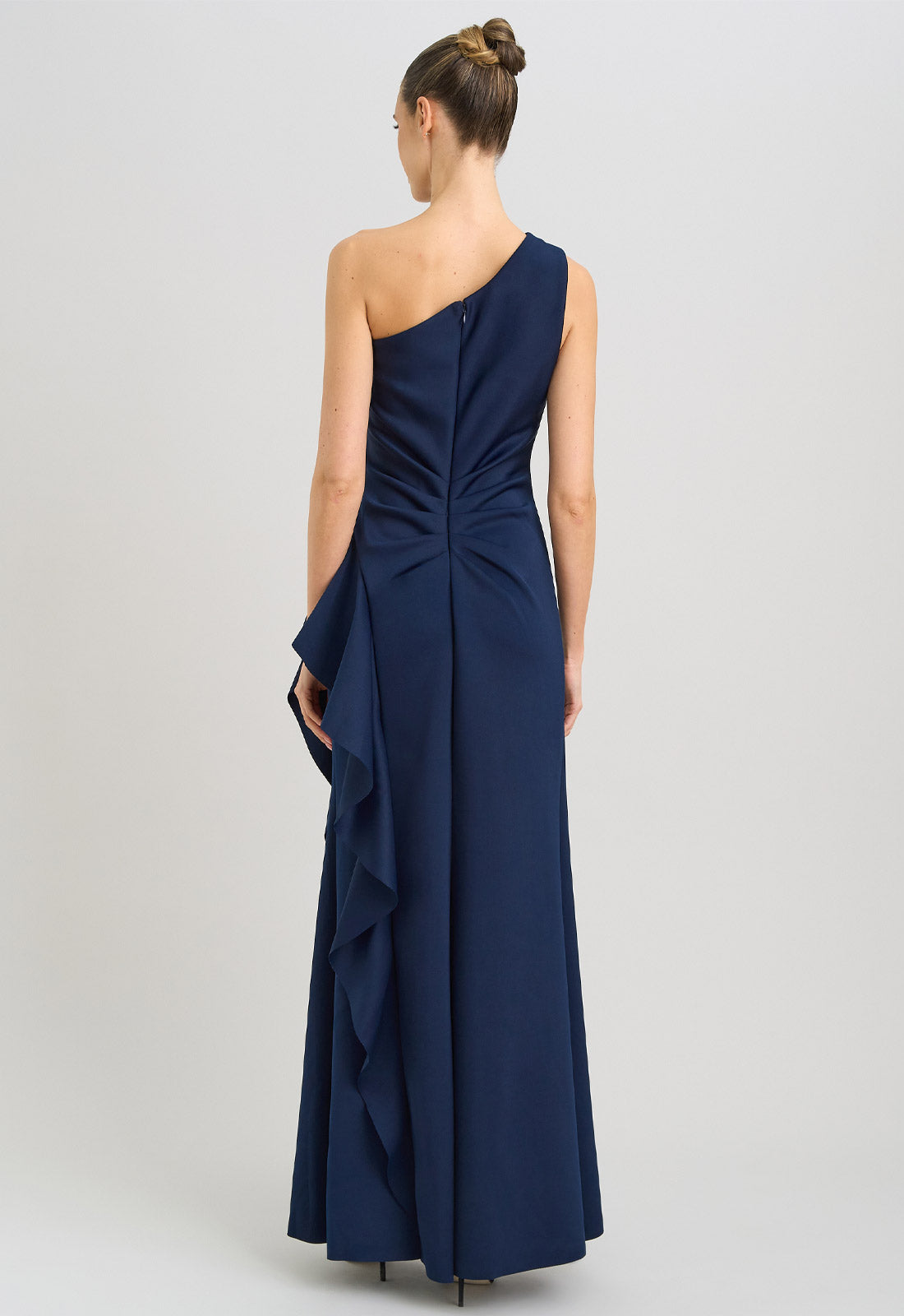 Navy one-shoulder dress with ruffle detail on a white background