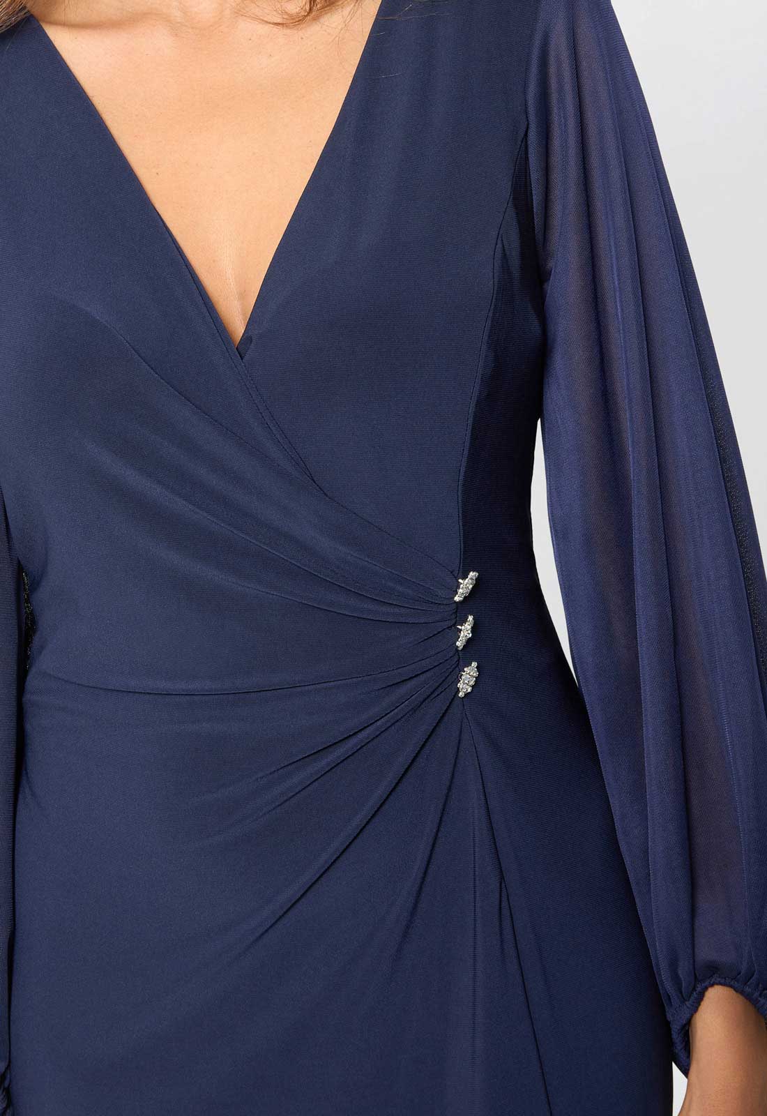 Navy blue dress with long sleeves and a V-neckline on a white background