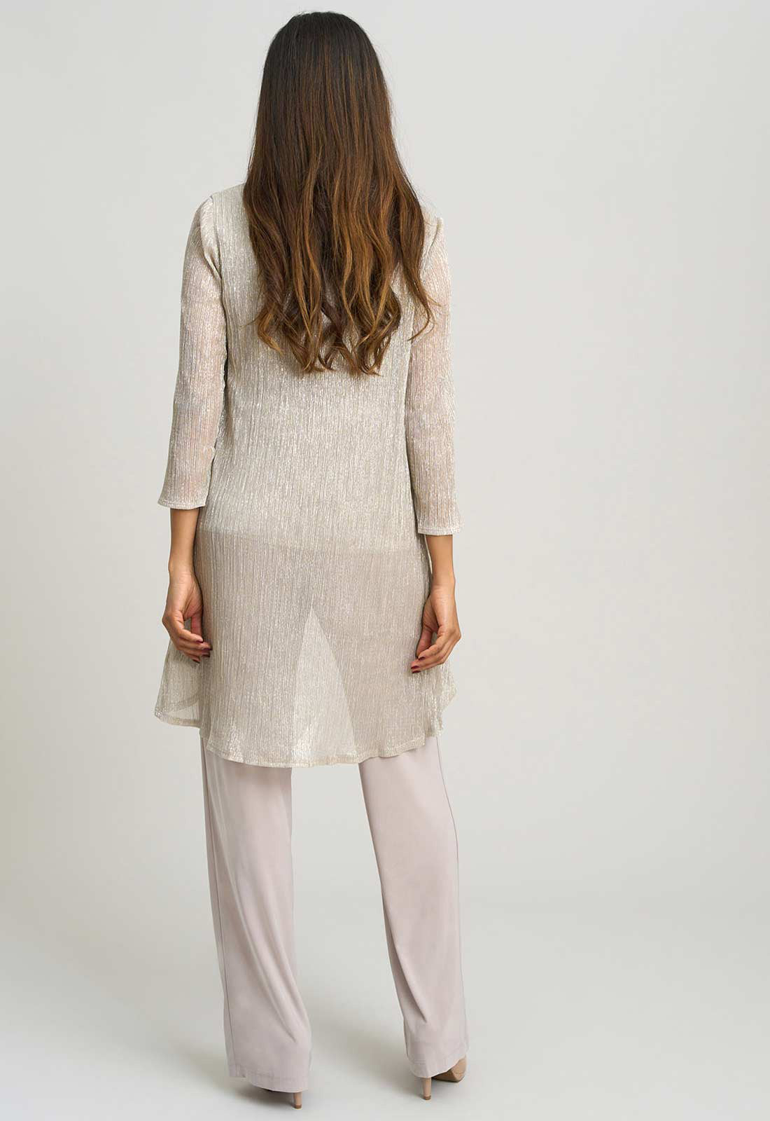 Woman wearing a light beige kurta with palazzo pants on a white background