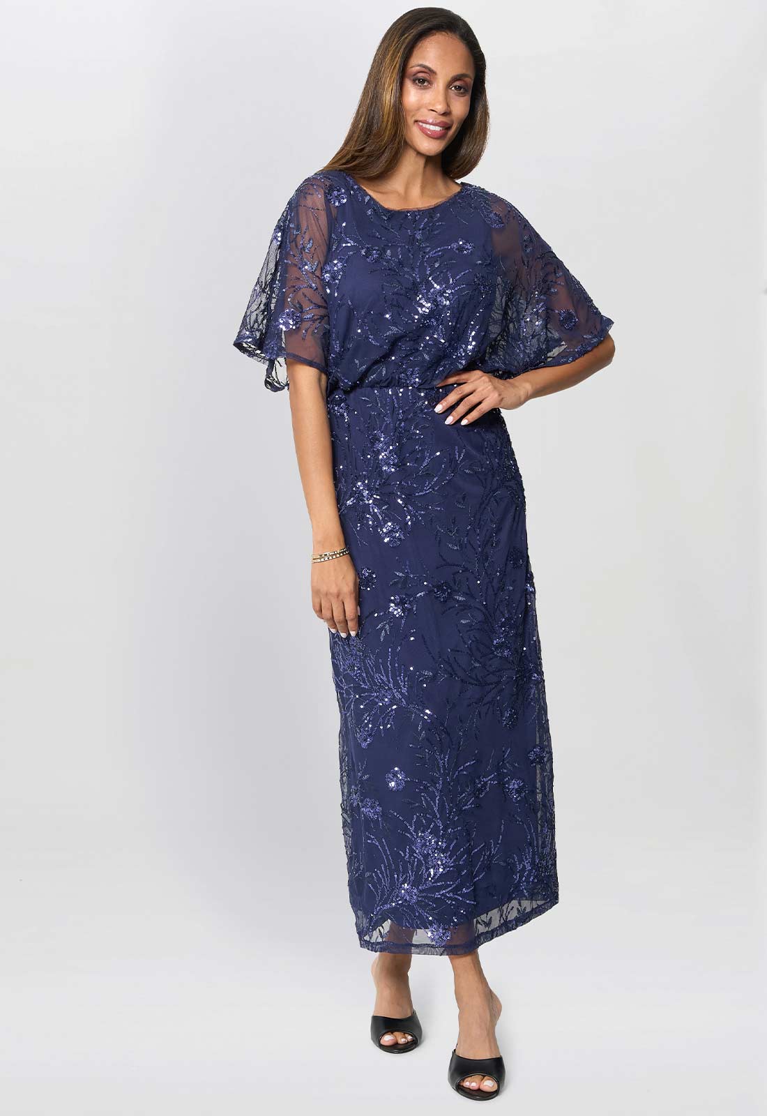 Woman wearing a navy blue lace dress on a white background