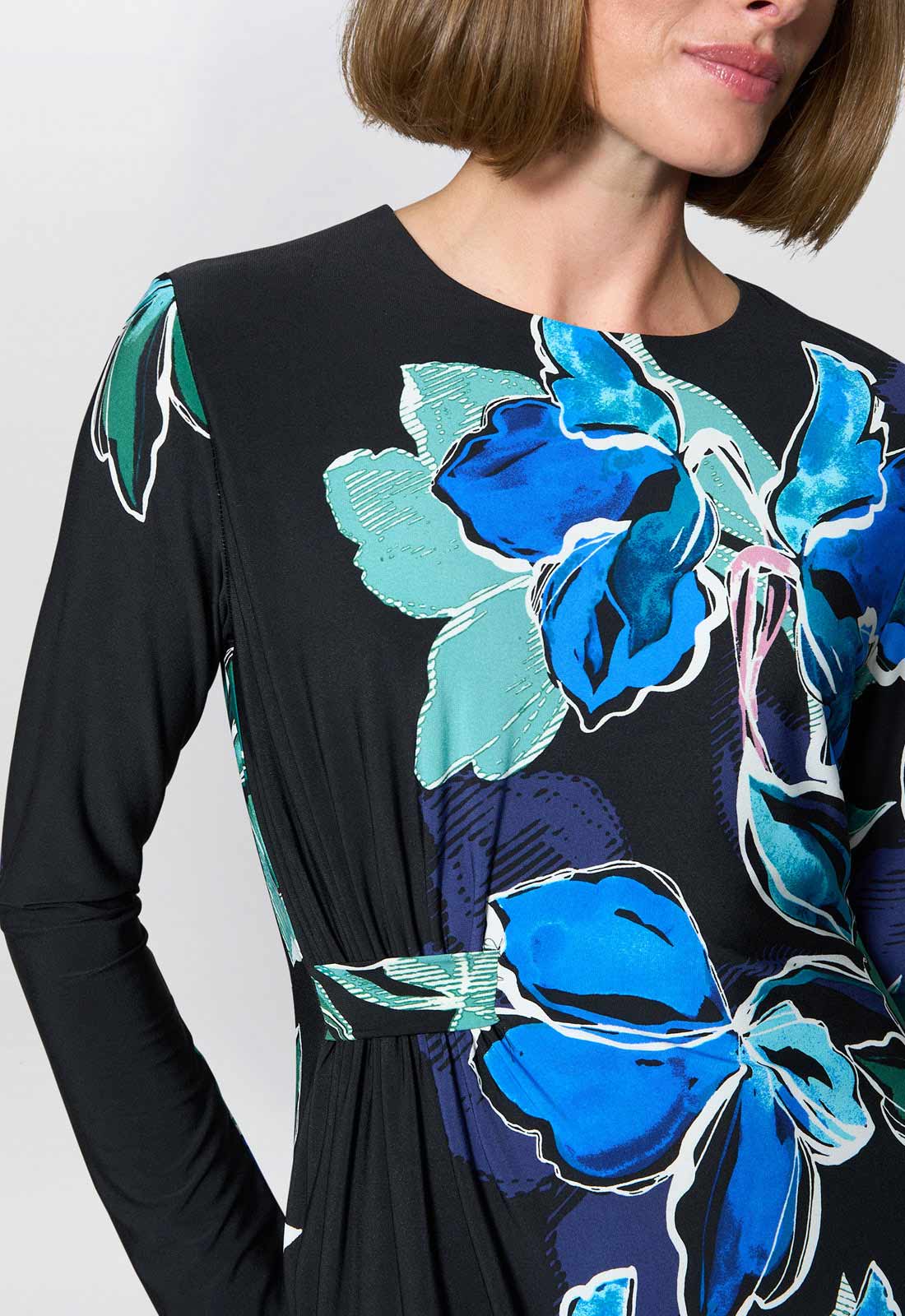 Black dress with blue floral patterns worn by a person