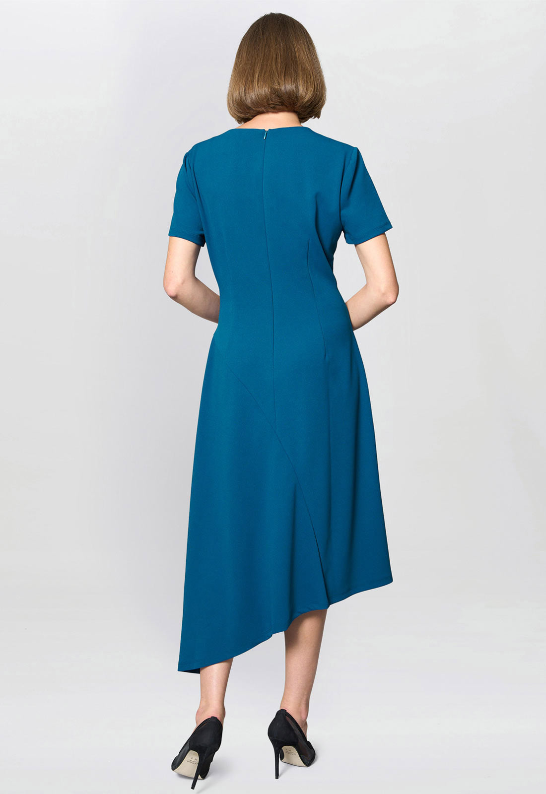 Woman wearing a blue dress on a white background