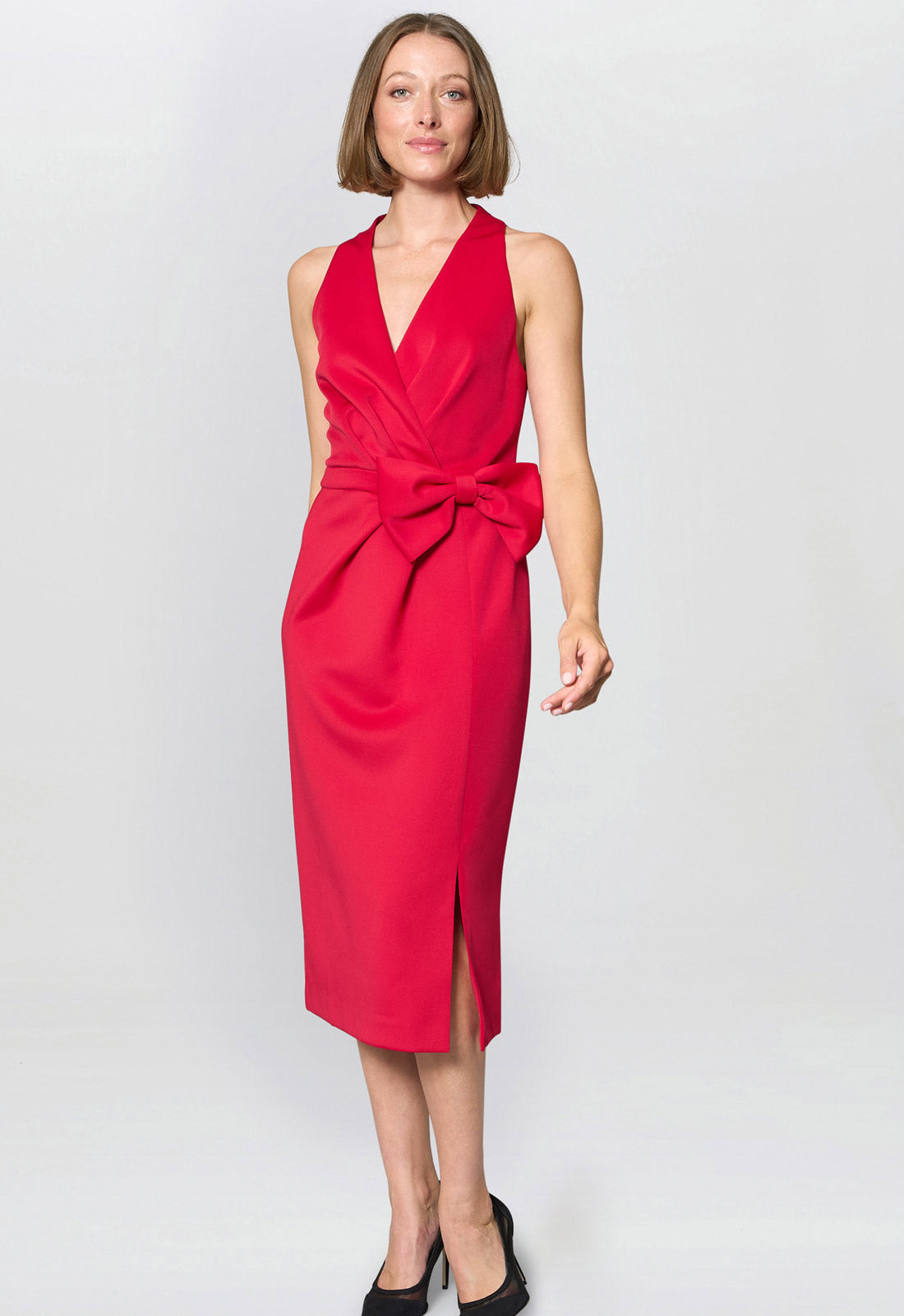 Woman wearing a red dress with a bow on a white background