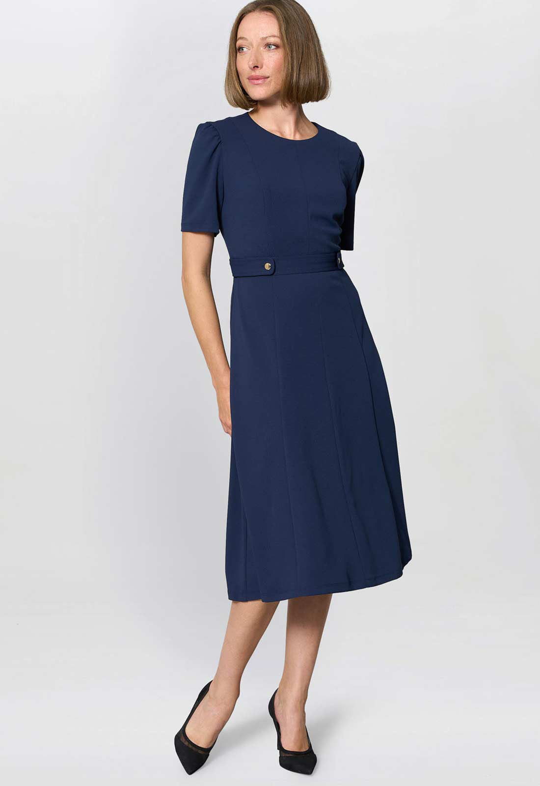 Woman wearing a navy blue dress on a white background