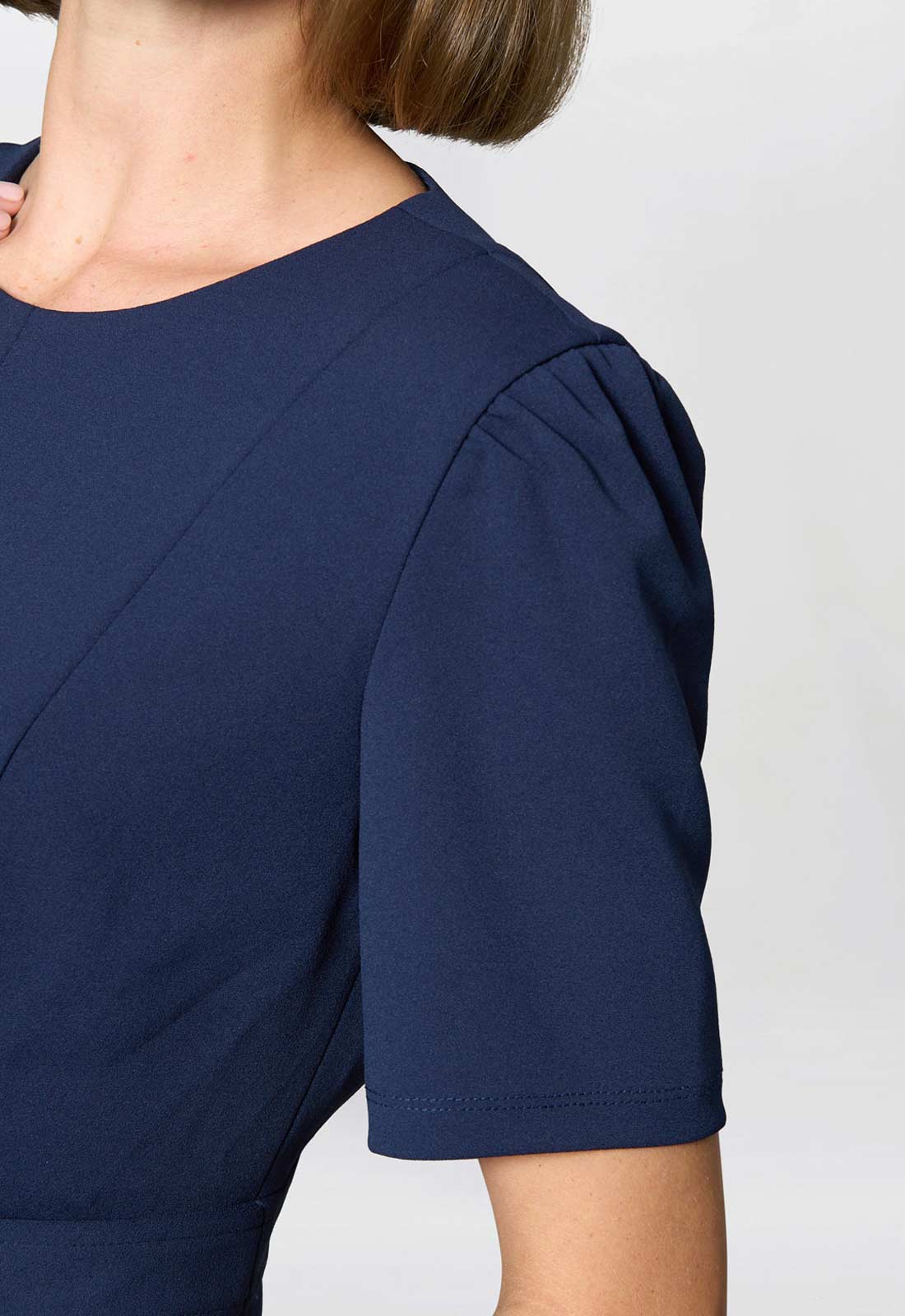 Navy blue dress with a plain background