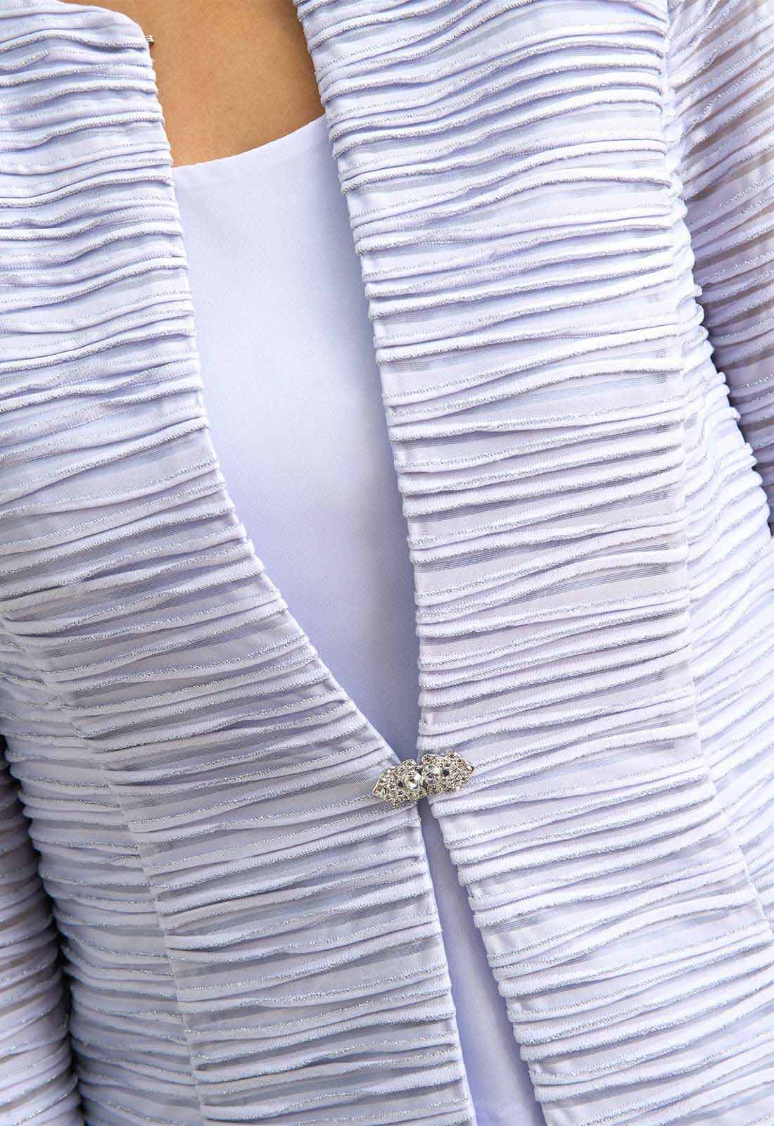 Close-up of a textured white garment with a subtle pattern