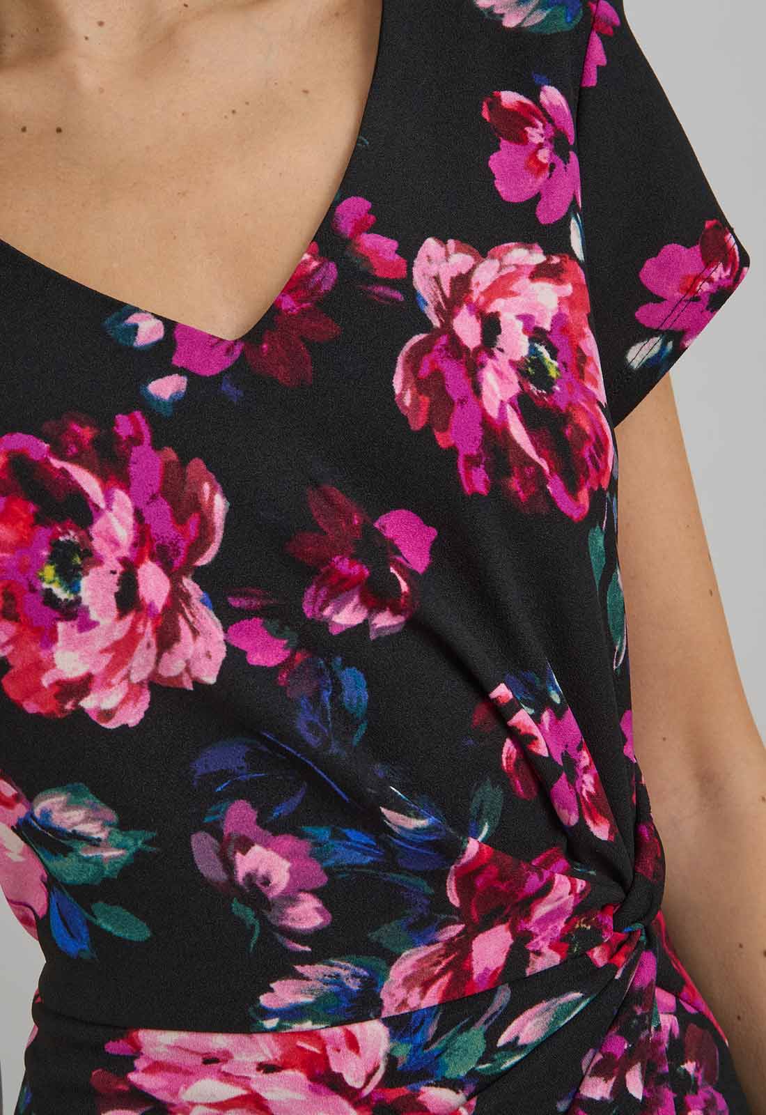 Close-up of a black dress with pink floral pattern