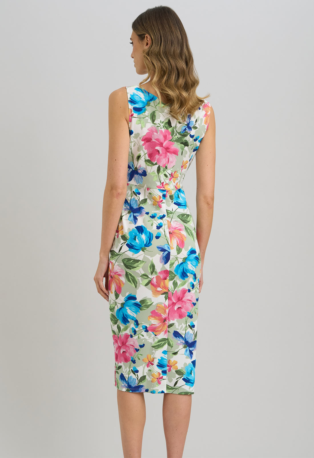 Woman wearing a floral dress on a plain background