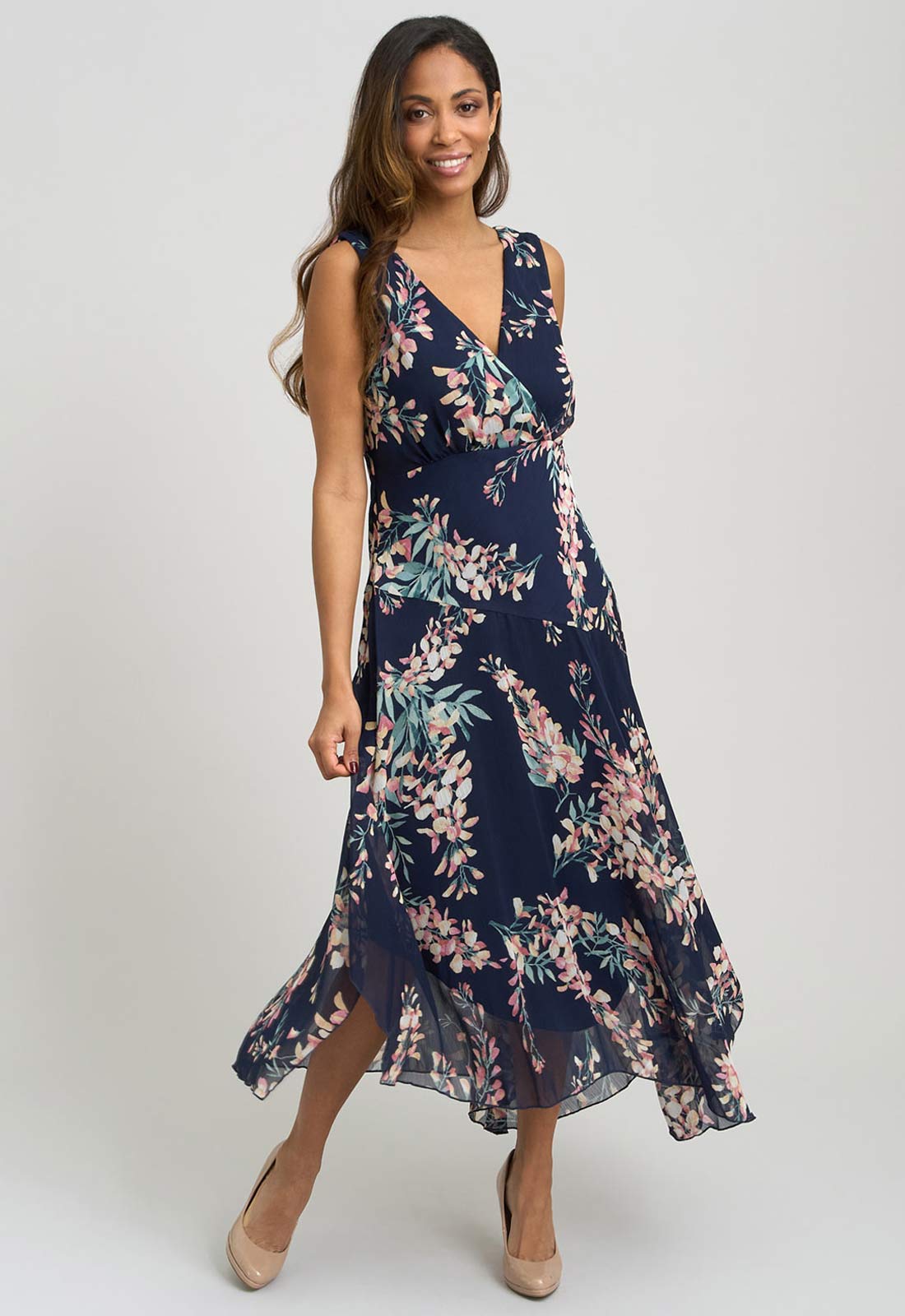 Woman wearing a navy floral dress on a white background
