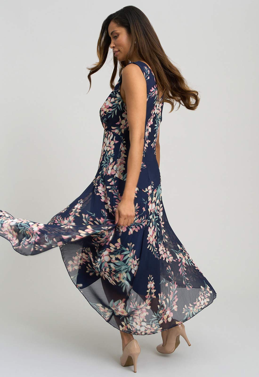 Woman wearing a navy floral dress on a white background
