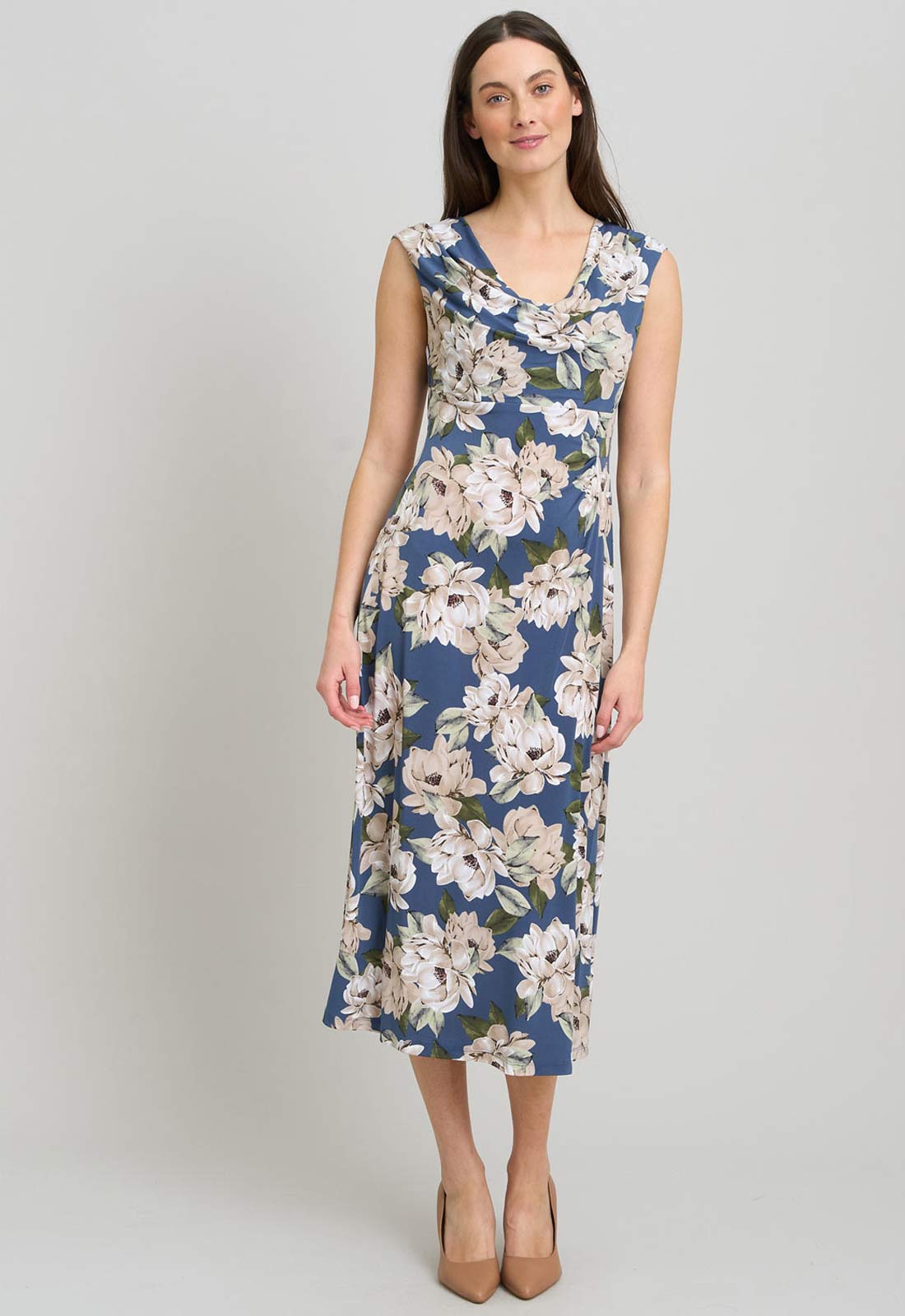 Woman wearing a floral dress on a plain background