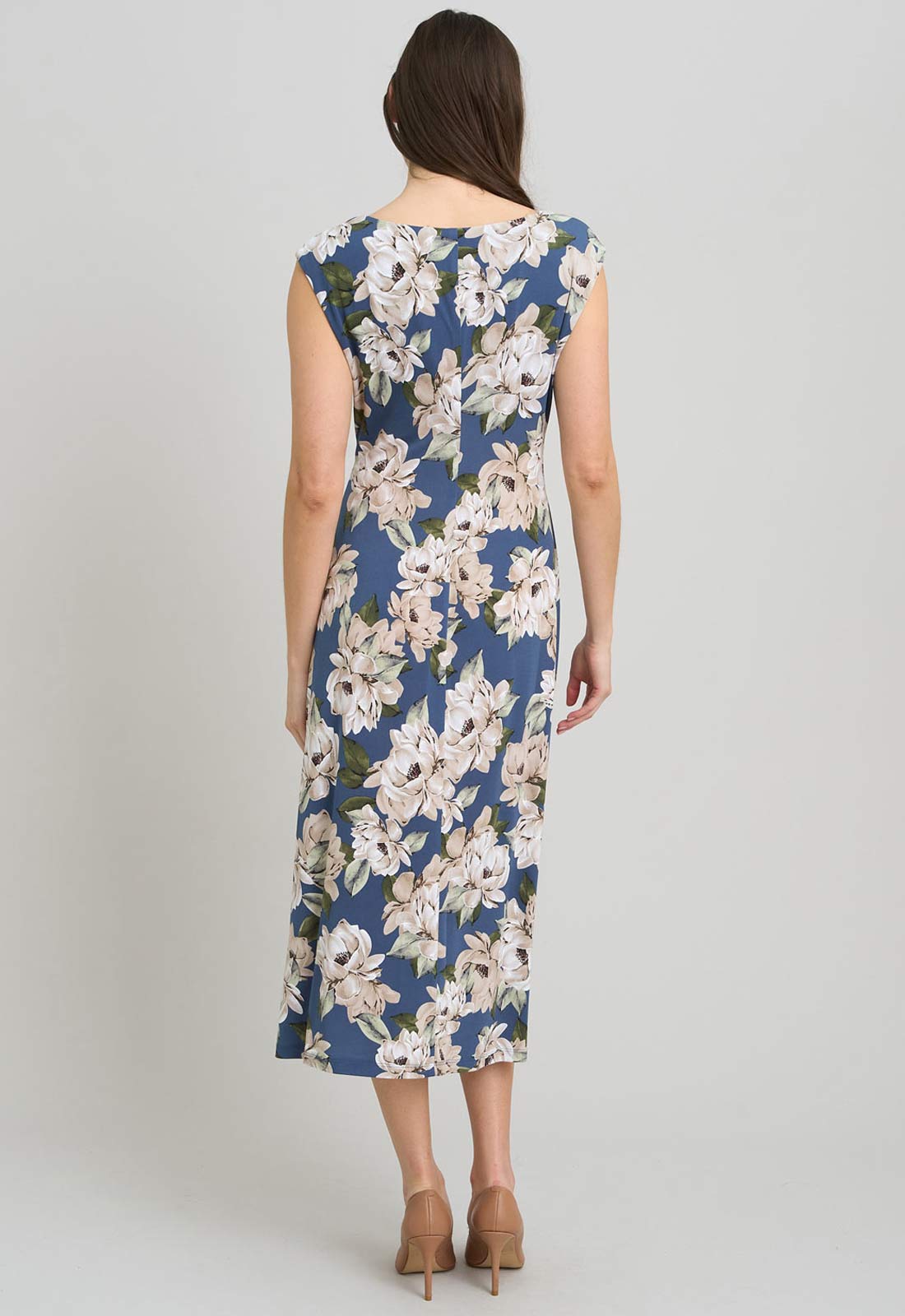 Woman wearing a floral dress on a plain background